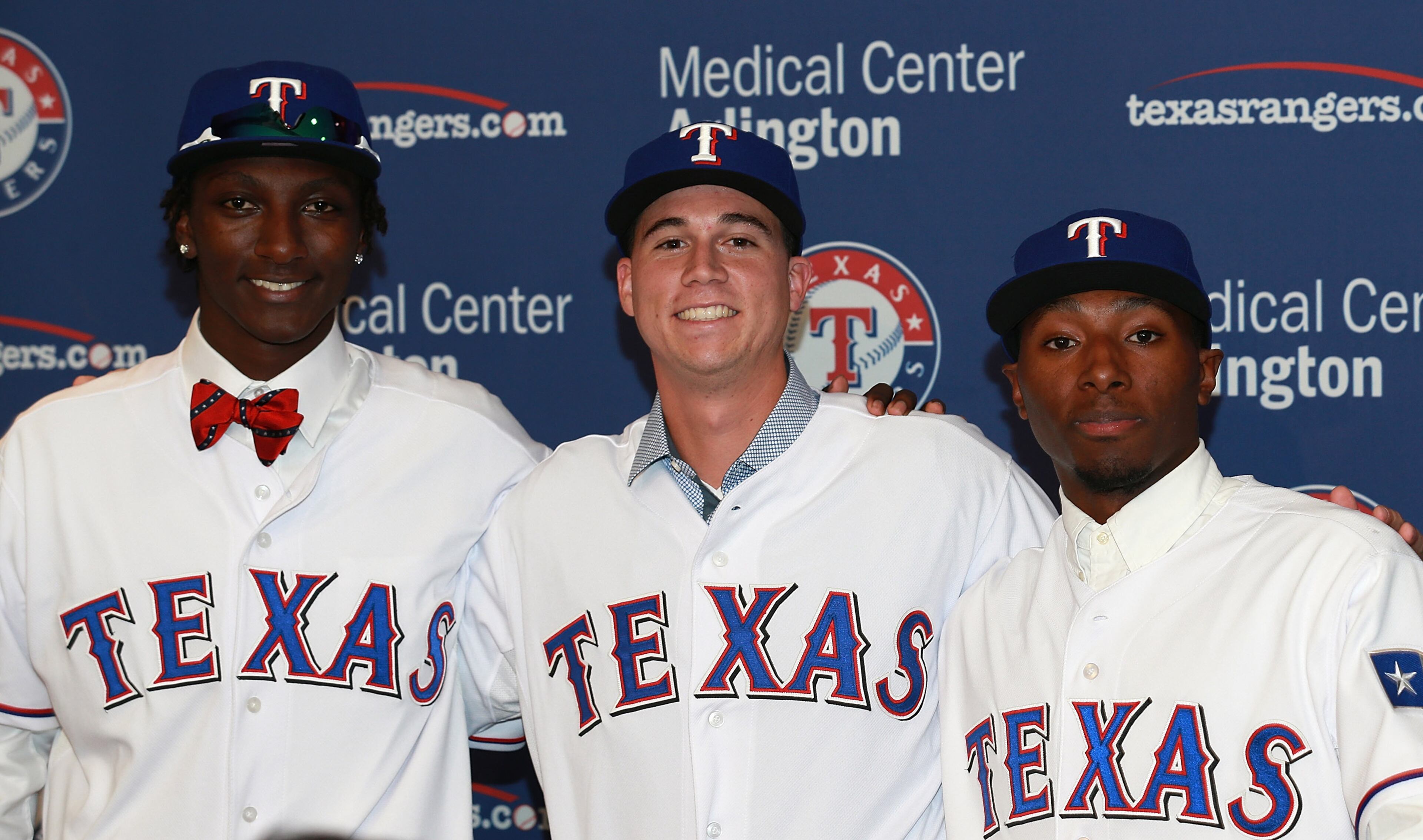Travis Demeritte (right) poses for a photo along with two other Texas Rangers draft picks in 2013. (Photo by Rick Yeatts/Getty Images)