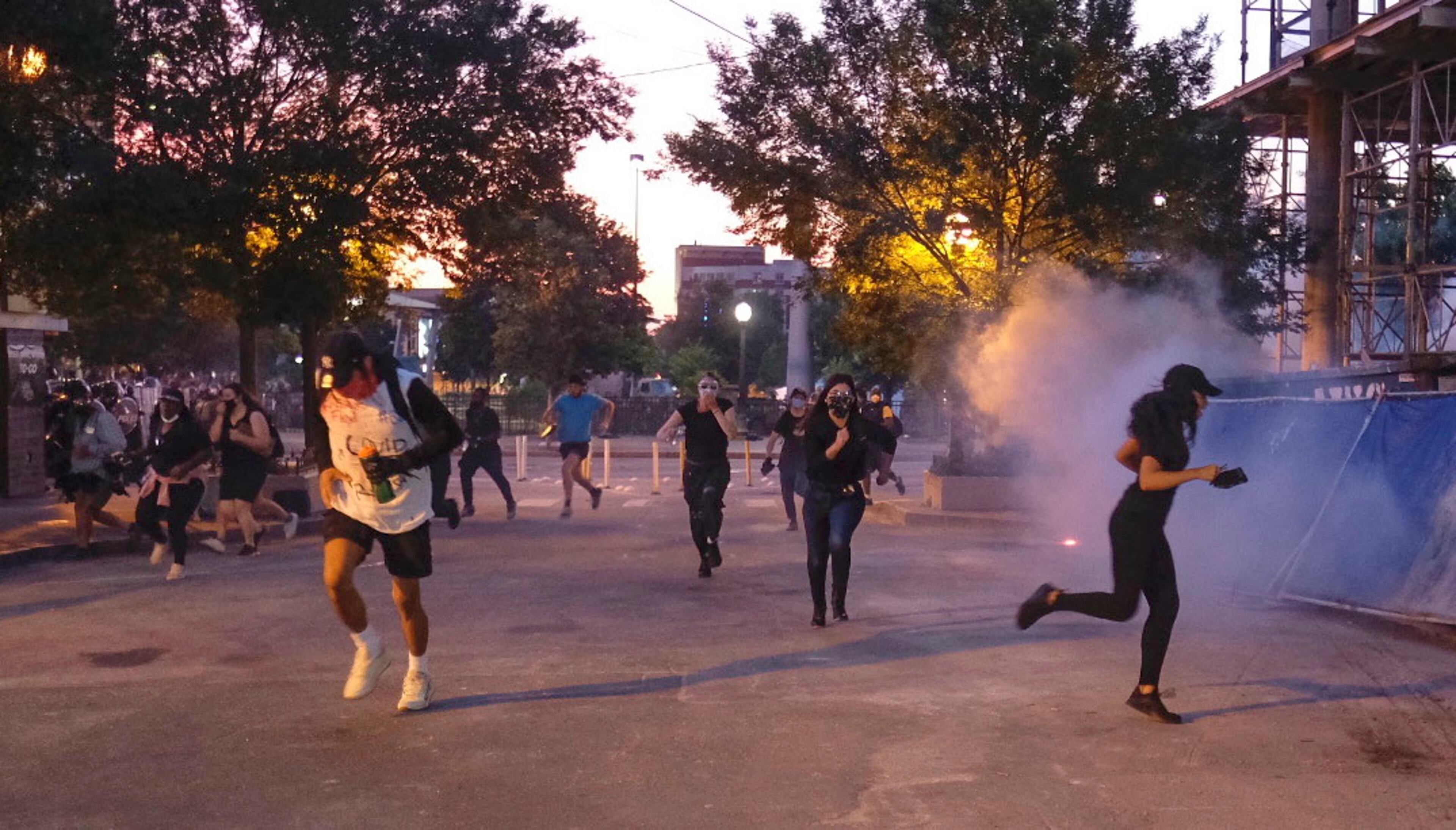 June 2, 2020 - Atlanta - Protestors dodge tear gas and police after the 9pm curfew in downtown Atlanta as protests continued for a fourth day. Protests over the death of George Floyd in Minneapolis police custody continued around the United States, as his case renewed anger about others involving African Americans, police and race relations. Ben Gray for the Atlanta Journal Constitution