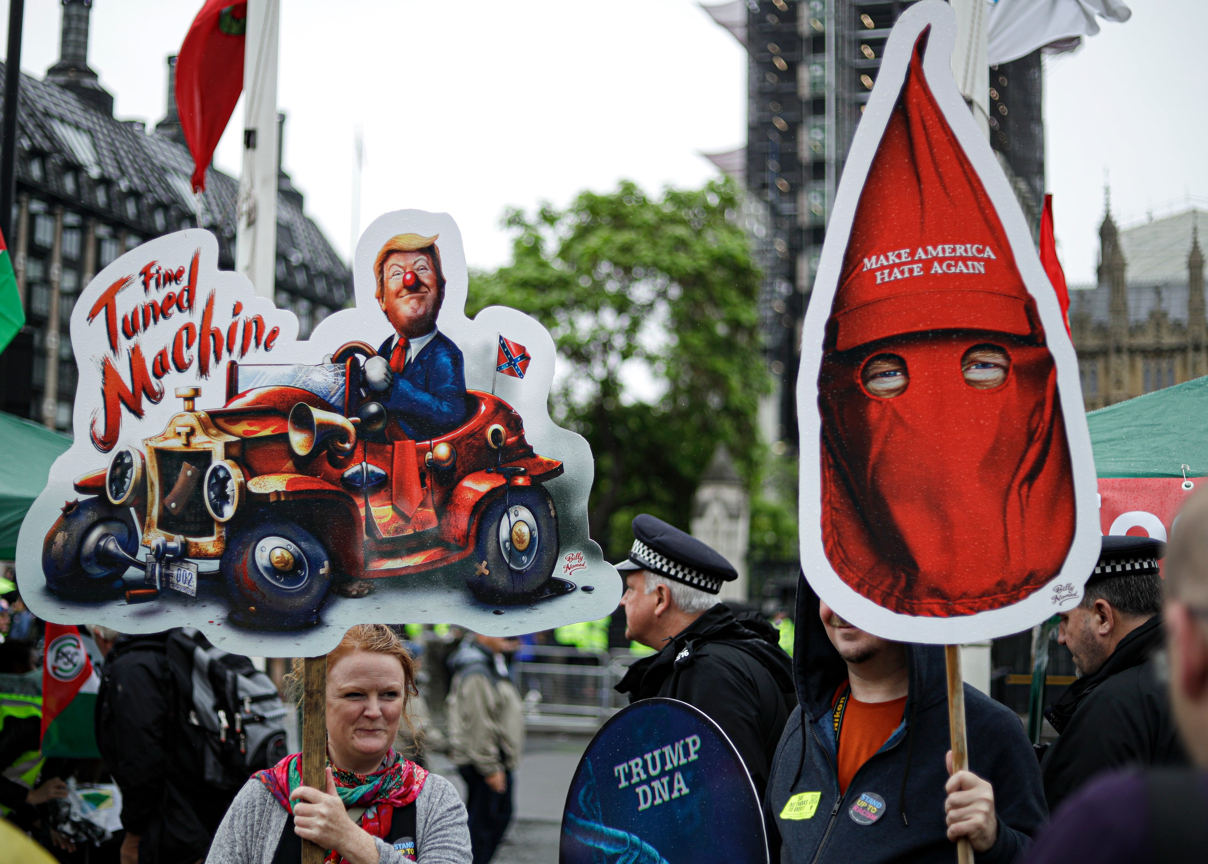 People hold placards with anti-Trump messages in central London, near the end of a protest against the state visit of President Donald Trump, Tuesday, June 4, 2019. Trump will turn from pageantry to policy Tuesday as he joins British Prime Minister Theresa May for a day of talks likely to highlight fresh uncertainty in the allies' storied relationship. (AP Photo/Matt Dunham)