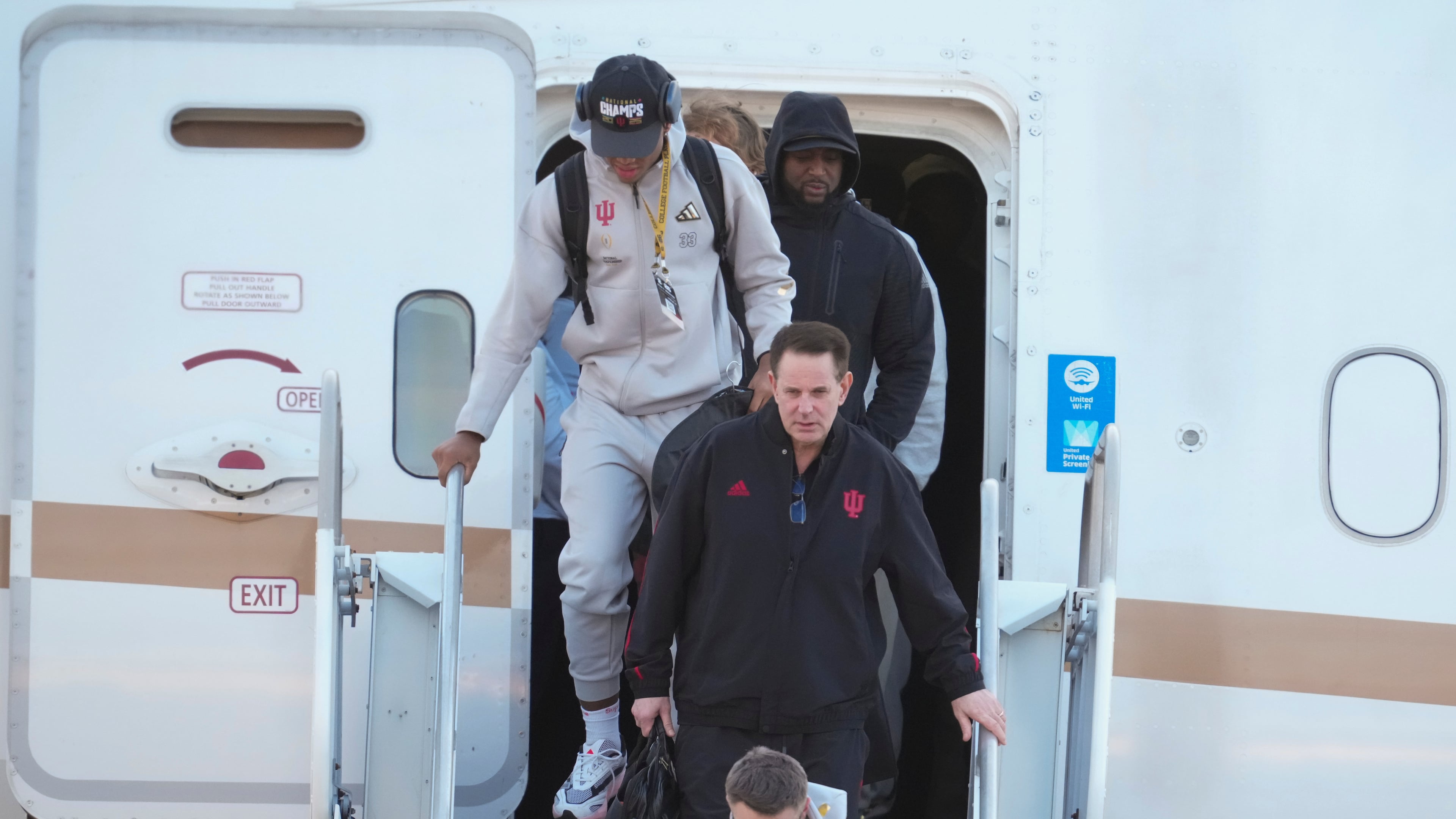 Indiana head coach Curt Cignetti, walks off the plane after the team arrived at the Indianapolis International Airport in Indianapolis, Tuesday, Jan. 20, 2026. (AP Photo/Michael Conroy)