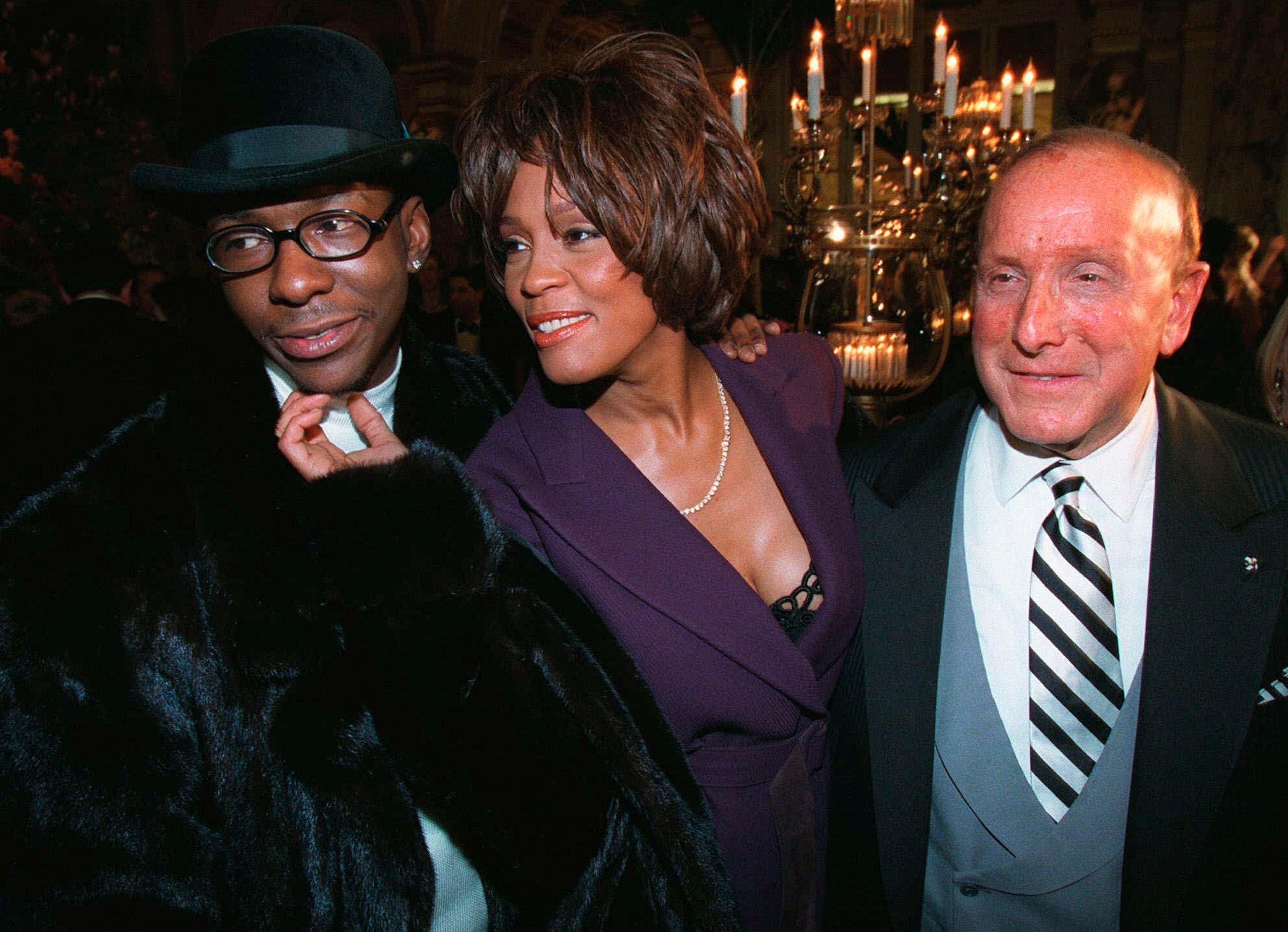 Bobby Brown, left, and Whitney Houston appear with music producer Clive Davis, right, at a pre-Grammy party in New York on Feb. 24, 1998. (Stuart Ramson/AP)