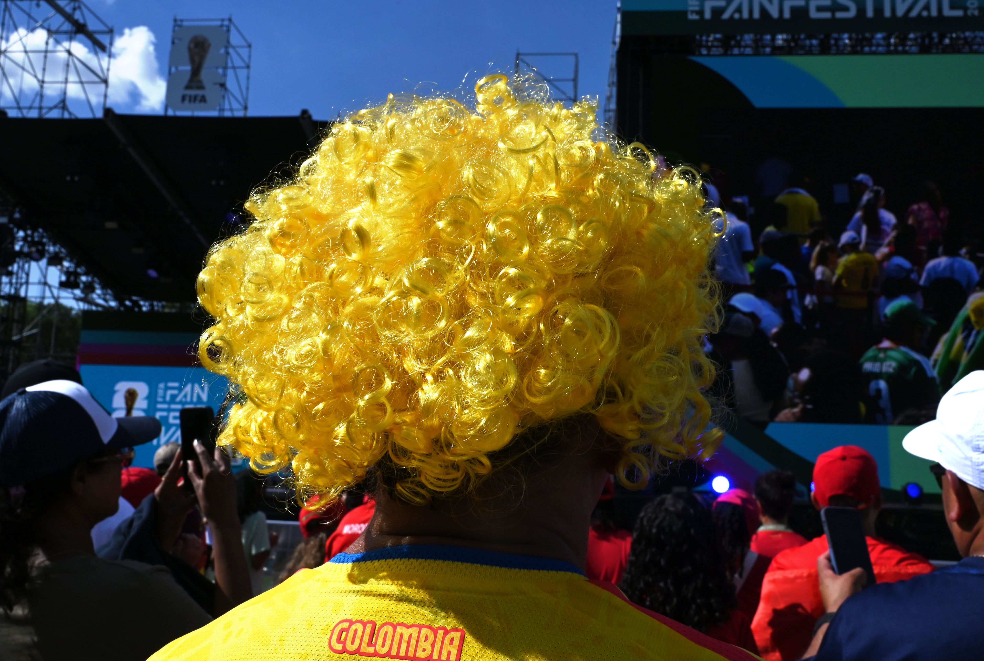 A Brazilian fan wears a yellow jersey and wig enjoys the atmosphere ahead of the match against Morocco at the FIFA Fan Festival. (Hyosub Shin/AJC)