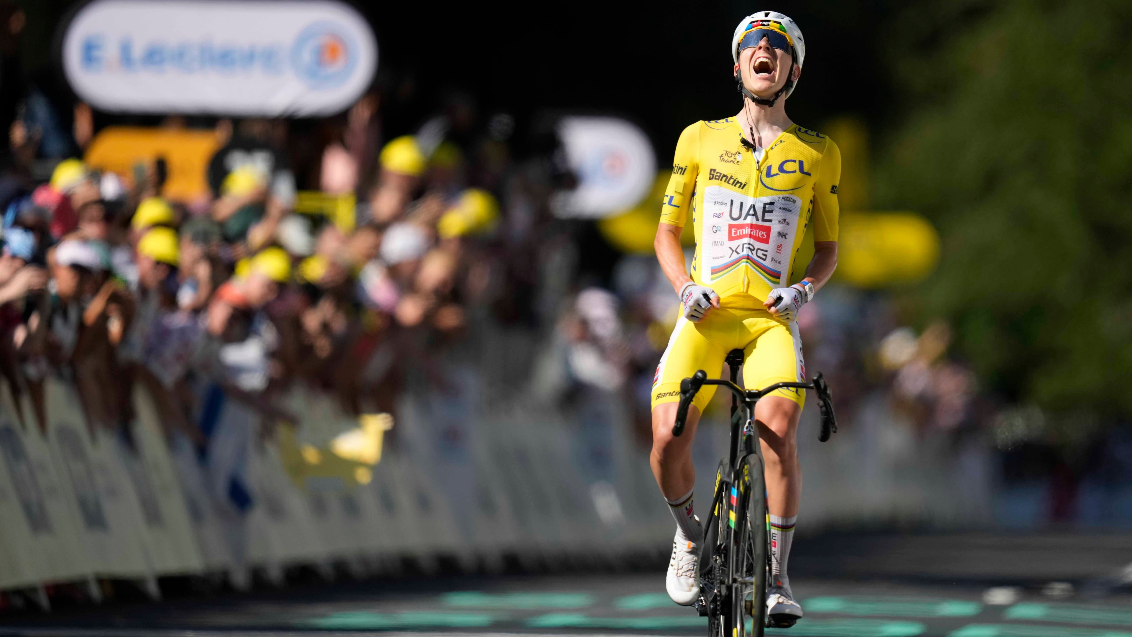 Slovenia's Tadej Pogacar, wearing the overall leader's yellow jersey, celebrates after winning the tenth stage of the Tour de France cycling race with start in Aurillac and finish in Le Lioran, France, Tuesday, July 14, 2026. (AP Photo/Mosa'ab Elshamy)