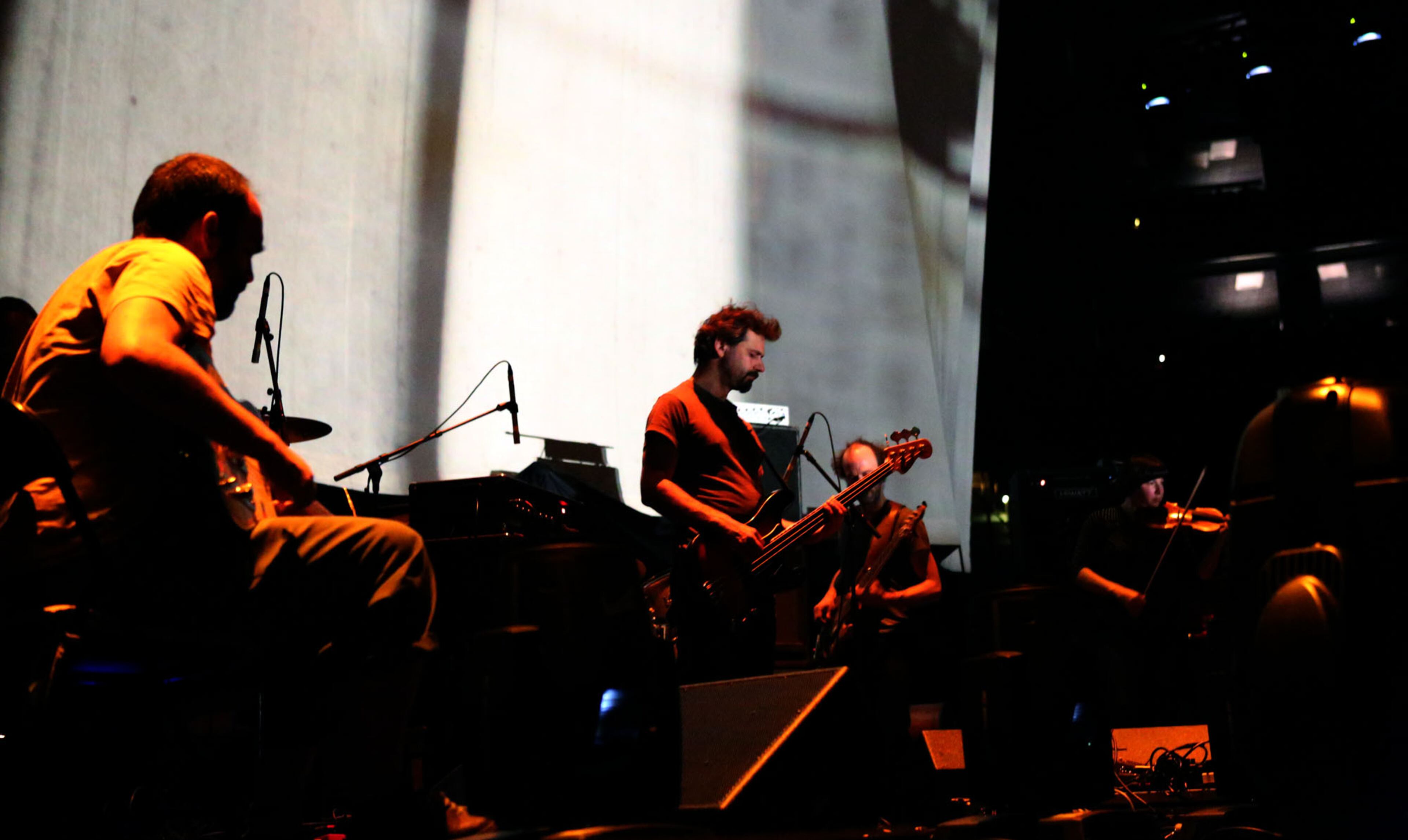 Canadian post-rock band Godspeed You! Black Emperor, perform primarily in darkness with a backdrop of black-and-white videos playing in the background while opening for Nine Inch Nails at Philips Arena in Atlanta Thursday, Oct. 24, 2013.