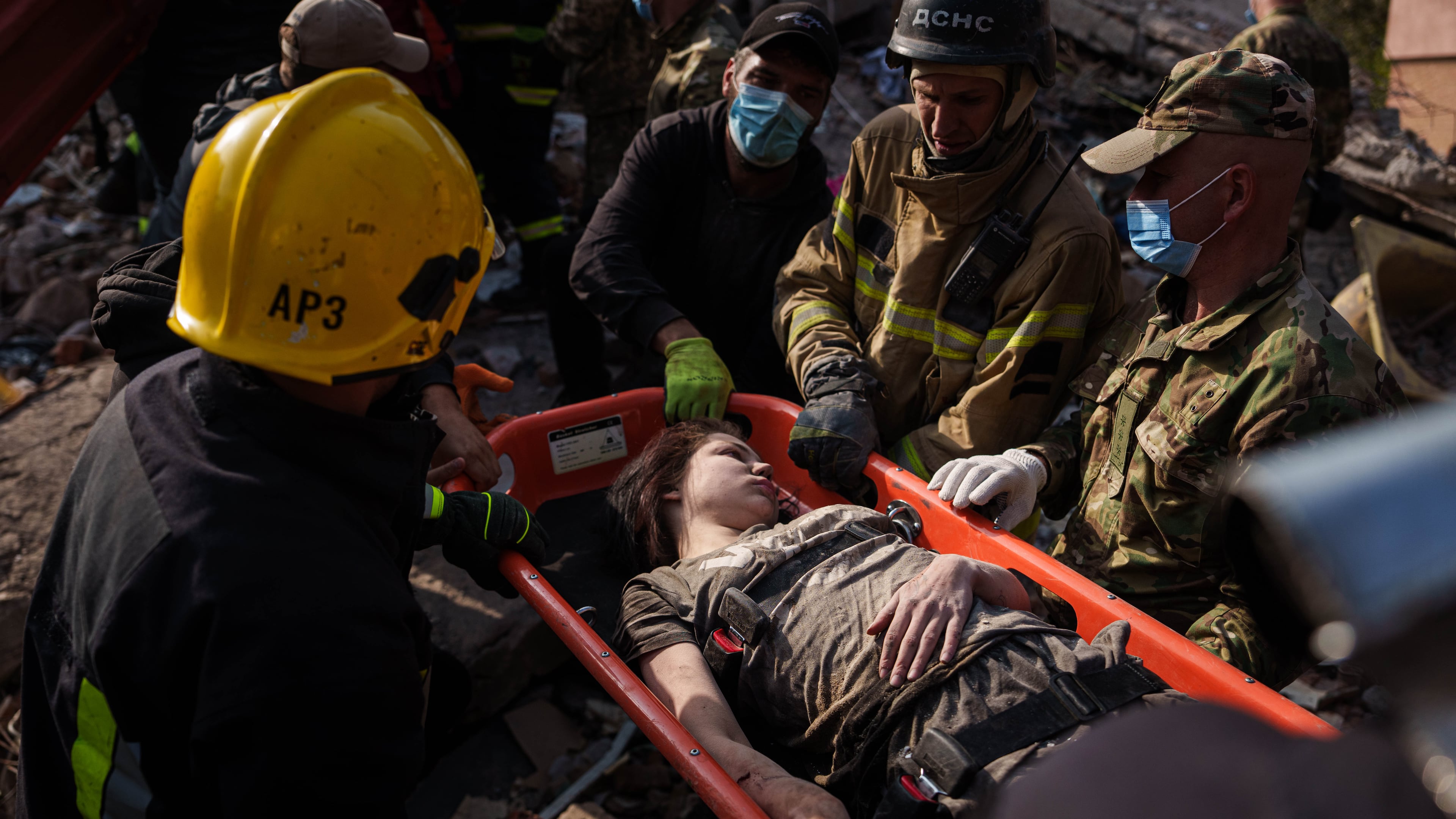 Locals and rescuers carry out an injured woman from a residential building destroyed in a Russian missile strike on Pryluky, Ukraine, Wednesday, Oct. 7, 2026. (AP Photo/Evgeniy Maloletka)