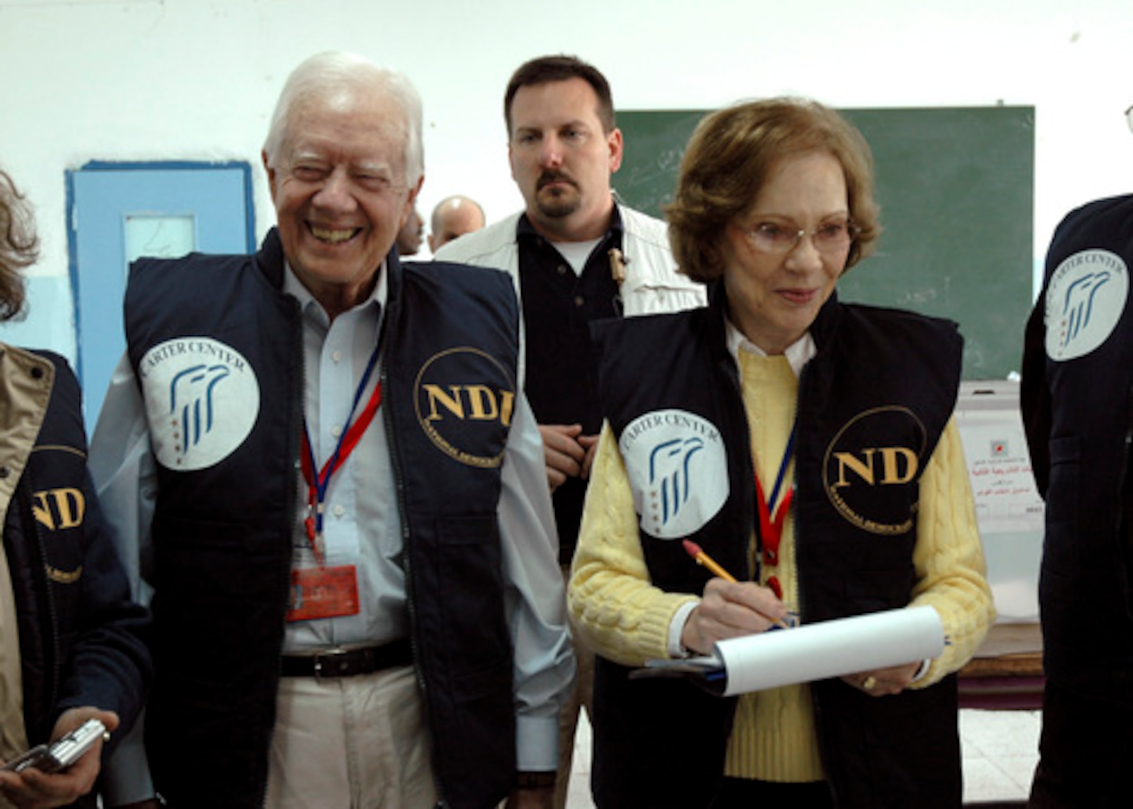 In this image released by the Carter Center, former U.S. President Jimmy Carter, left, and his wife Rosalyn smile as they visit a polling station during the Palestinian parliamentary elections in Arab east Jerusalem on Jan. 25, 2006. Nearly 20,000 local observers and 950 international monitors, led by Carter, watched the vote. (AP Photo/Deborah Hakes, The Carter Center)