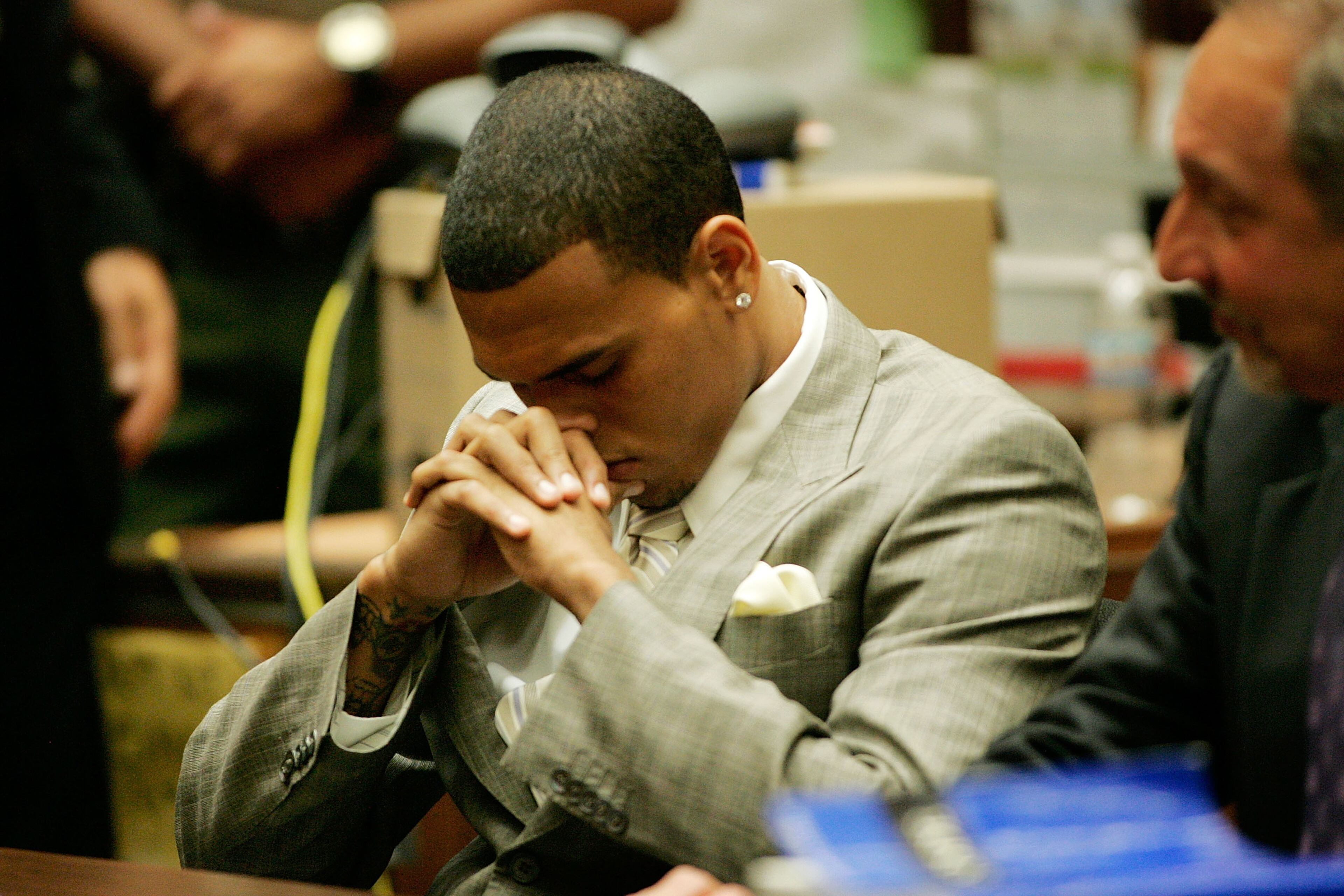 Singer Chris Brown looks down as he appears in the Criminal Courts Building where he reached a plea bargain for allegedly attacking pop singer Rihanna during a hearing at Superior Court of Los Angeles County on June 22, 2009 in Los Angeles, California. He is currently free on $50,000 bail. (Photo by Lori Shepler-Pool/Getty Images)