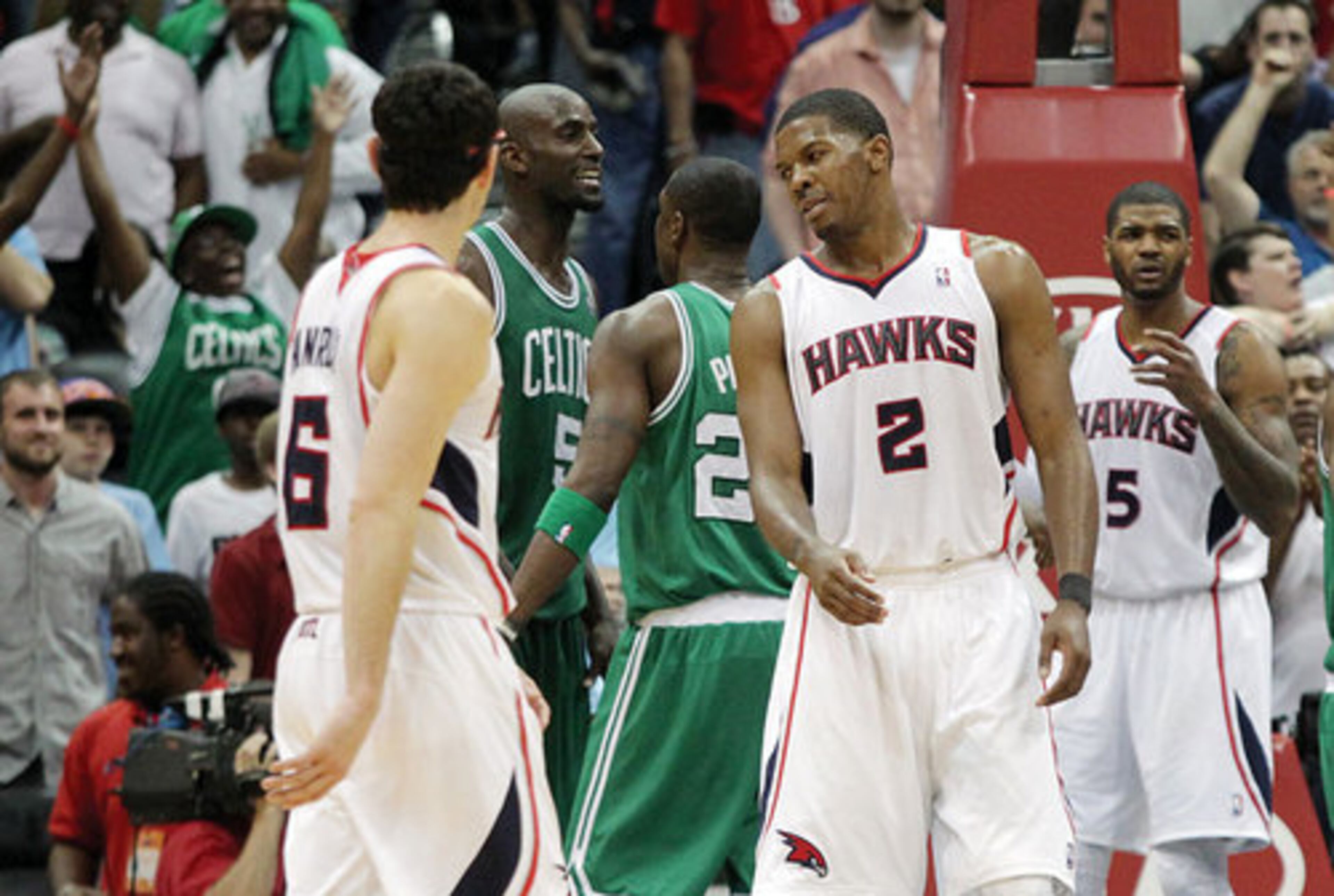 Boston Celtics Kevin Garnett and Mickael Pietrus celebrate while the Atlanta Hawks Kirk Hinrich (from left), Joe Johnson and Josh Smith react to a 3-point attempt by Jeff Teague that could have tied the game.