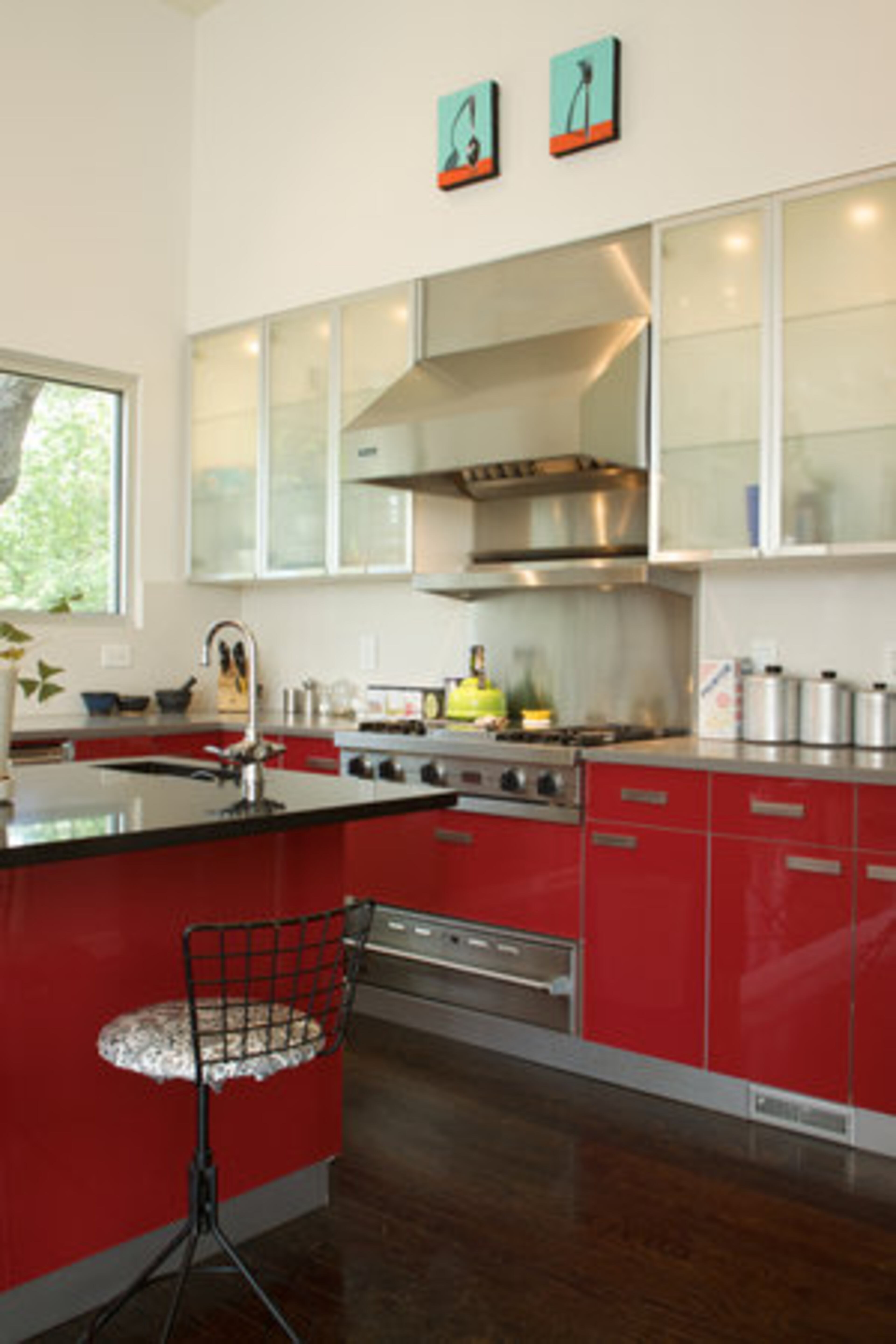 The countertops in the Beals' kitchen are syle stone and granite with red Ikea cabinets."We decided to save money on cabinets so we could splurge on Viking appliances," Justin Beals says.