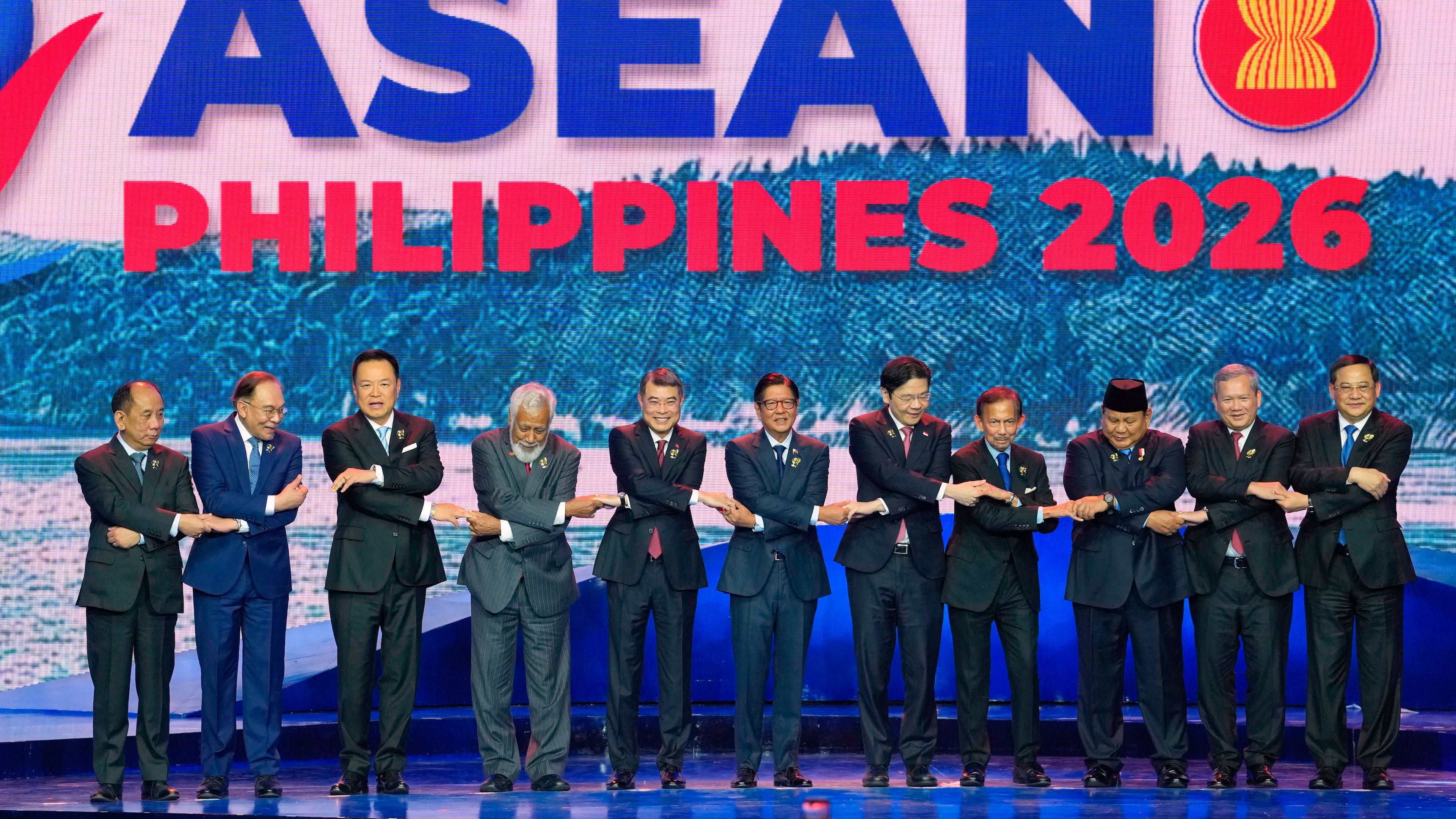 From left, Myanmar's Permanent Secretary of the Ministry of Foreign Affairs U Hau Khan Sum, Malaysia's Prime Minister Anwar Ibrahim, Thailand's Prime Minister Anutin Charnvirakul, East Timor's Prime Minister Xanana Gusmao, Vietnam's Prime Minister Le Minh Hung, Philippine President Ferdinand Marcos Jr., Singapore's Prime Minister Lawrence Wong, Brunei's Sultan Hassanal Bolkiah, Indonesia's President Prabowo Subianto, Cambodia's Prime Minister Hun Manet, and Laos' Prime Minister Sonexay Siphandone hold hands for a group photo during the opening ceremony of the 48th ASEAN summit and Related Meeting in Cebu, Philippines on Friday, May 8, 2026. (AP Photo/Aaron Favila, Pool)