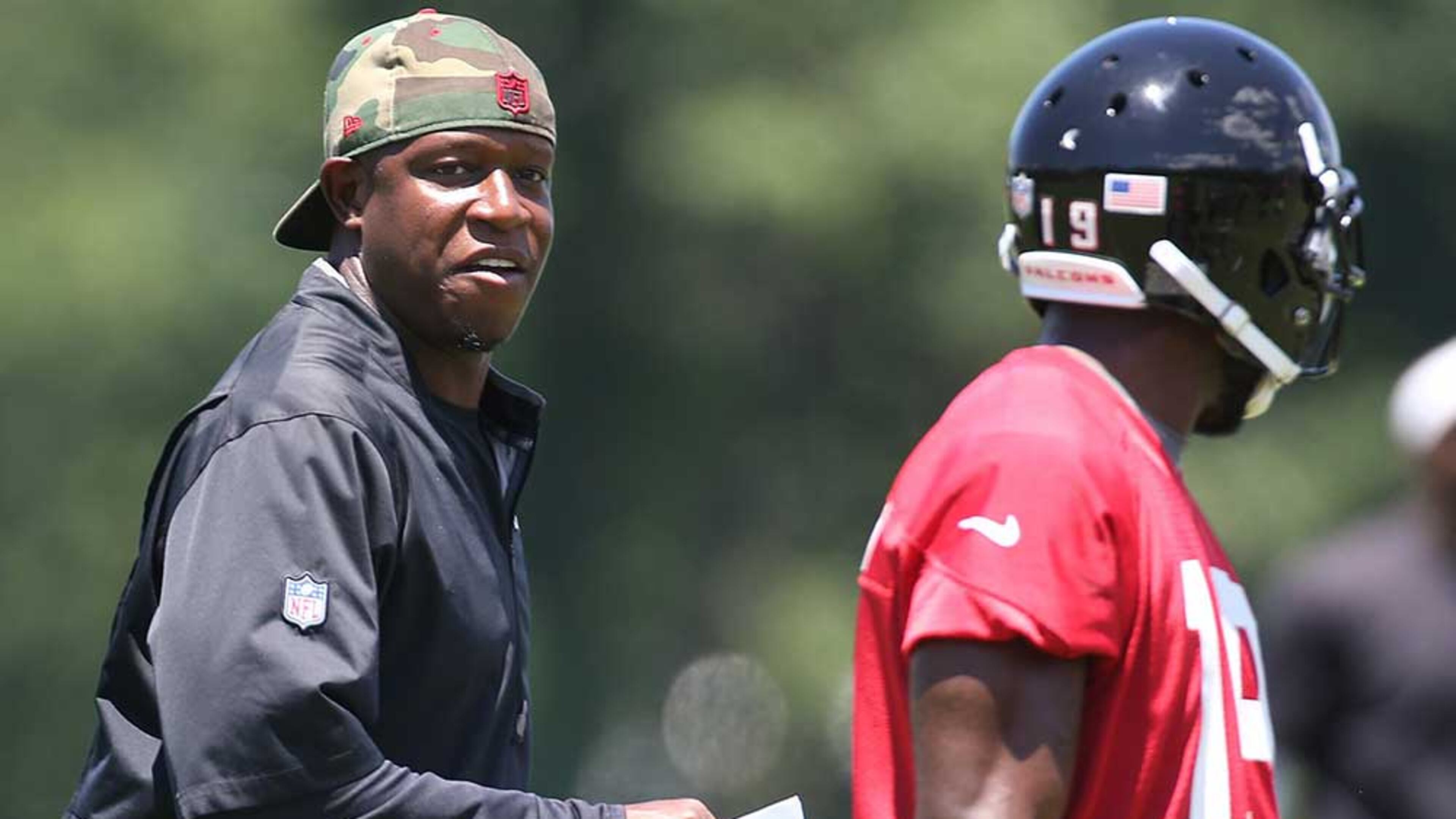 Falcons assistant head coach/wide receivers Raheem Morris chats up wide receiver Aldrick Robinson after a play during an OTA day on Tuesday, June 7, 2016, in Flowery Branch.