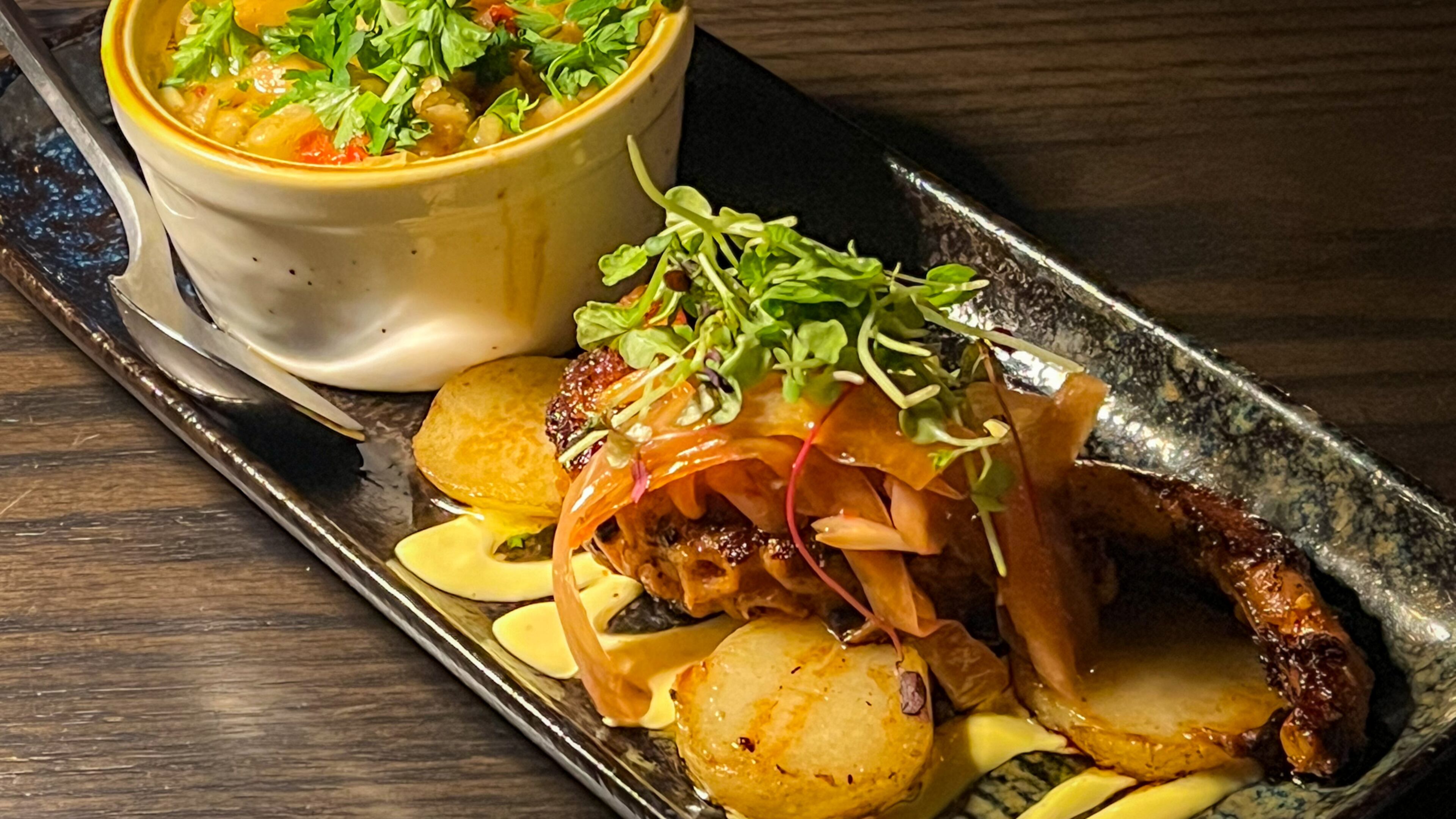 Pulpo parrilla, or grilled octopus, is served with a side of excellent white beans at Silla del Toro's new location in the Toco Hill shopping center. Henri Hollis/henri.hollis@ajc.com