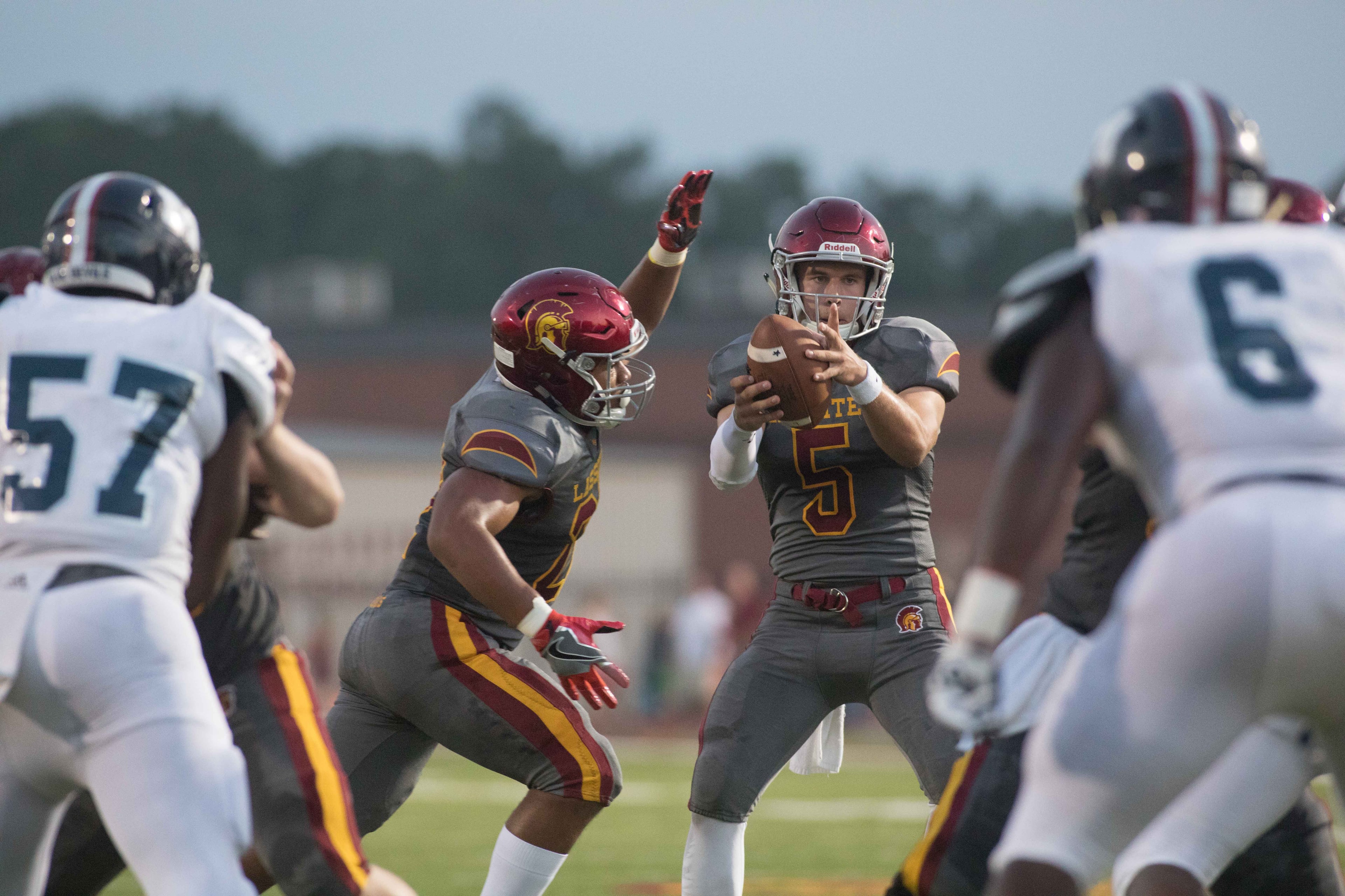 Lassiter High School quarterback Bradley Riopelle (5) catches a snap during a football game against Marietta High School, Friday, Sept. 15, 2017, in Marietta, Ga. BRANDEN CAMP/SPECIAL