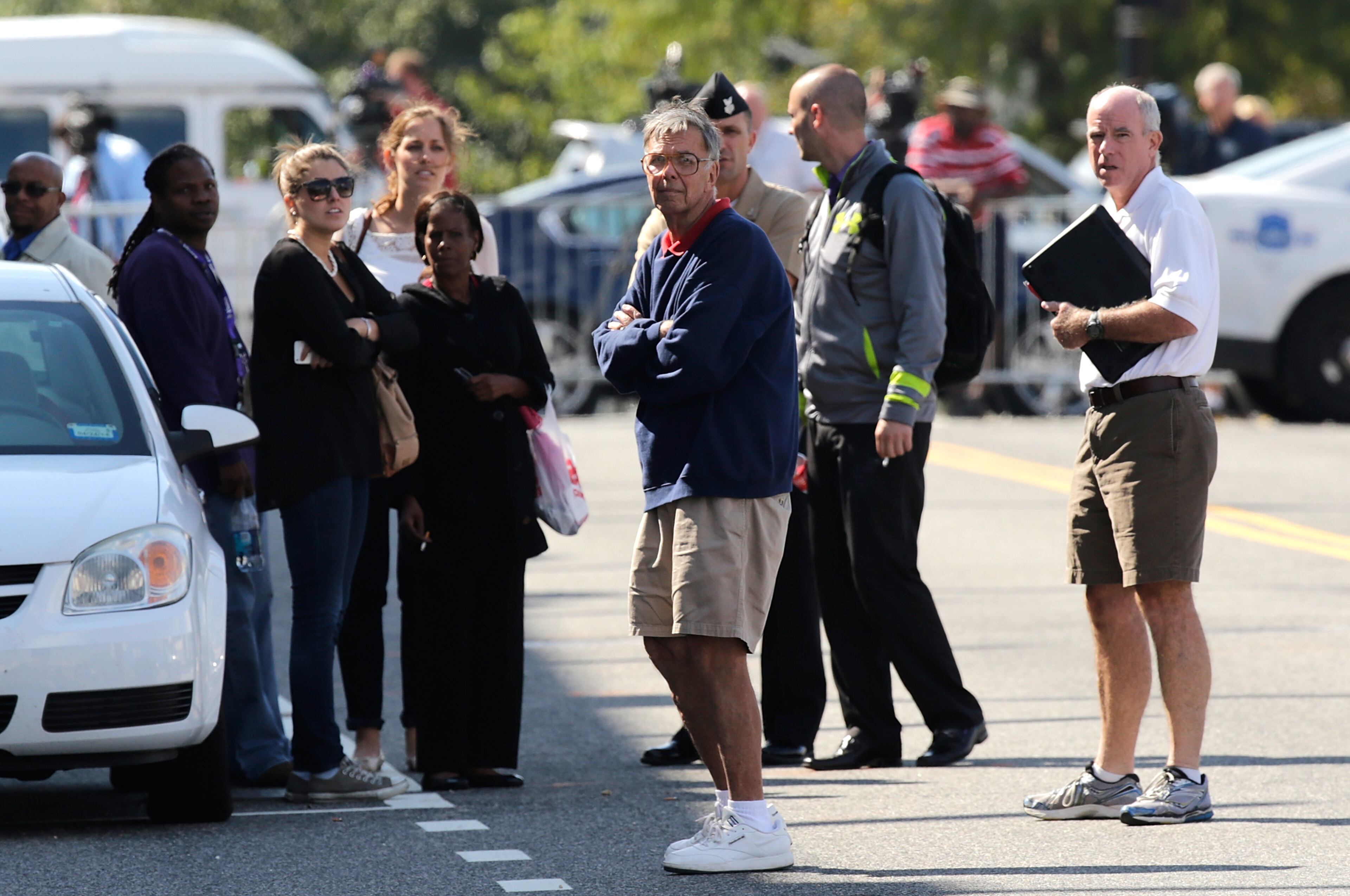 Family members of Navy Yard complex employees gather outside a parking lot that was converted to a point of reunion at Nationals Park in the wake of the Navy Yard shooting Sept. 16, 2013, in Washington, D.C.