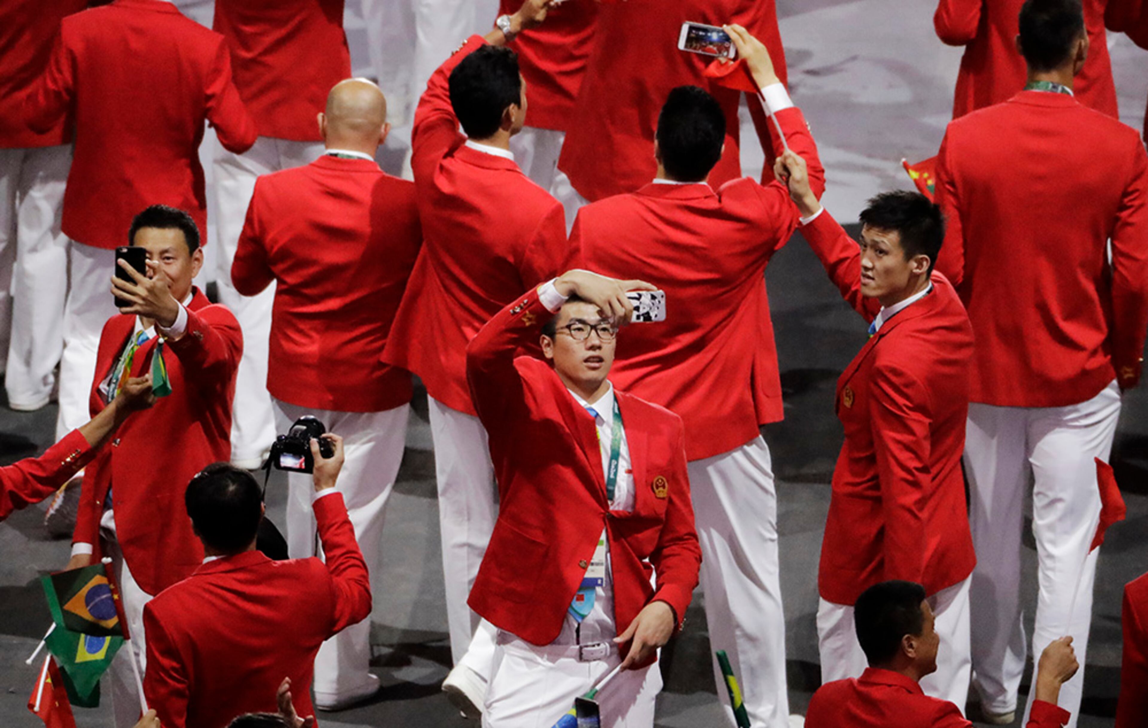 Members of team China take pictures during the opening ceremony for the 2016 Summer Olympics in Rio de Janeiro, Brazil, Friday, Aug. 5, 2016.