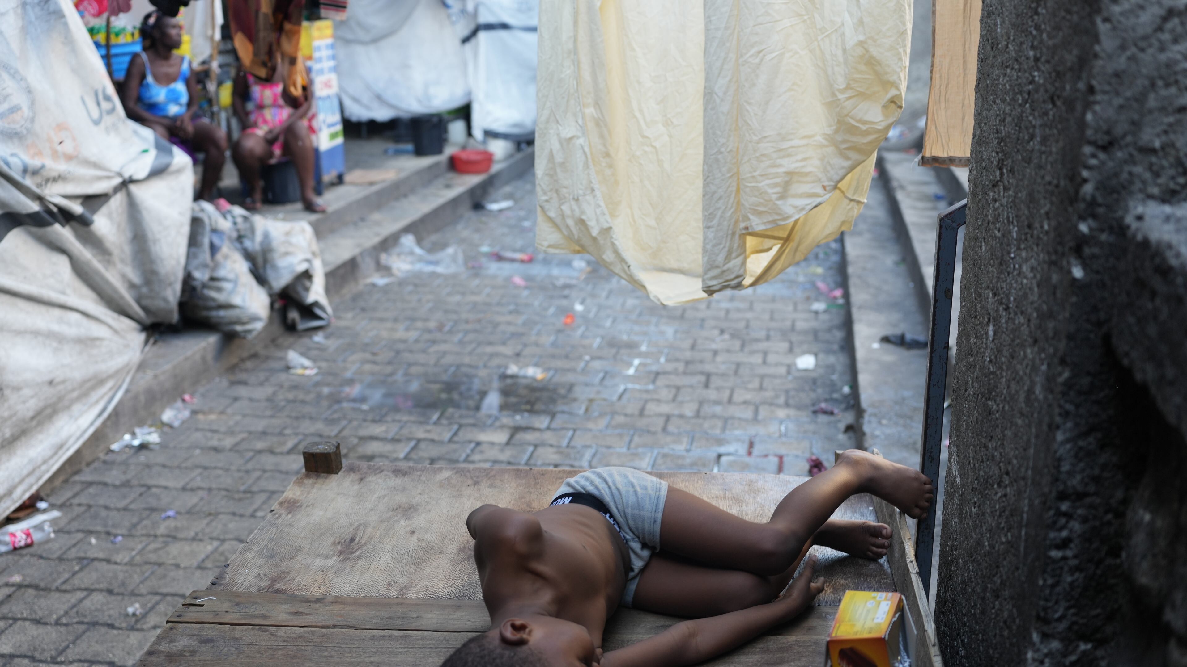 A child sleeps at a shelter for families displaced by gang violence in Port-au-Prince, Haiti, Tuesday, Jan. 27, 2026. (AP Photo/Odelyn Joseph)