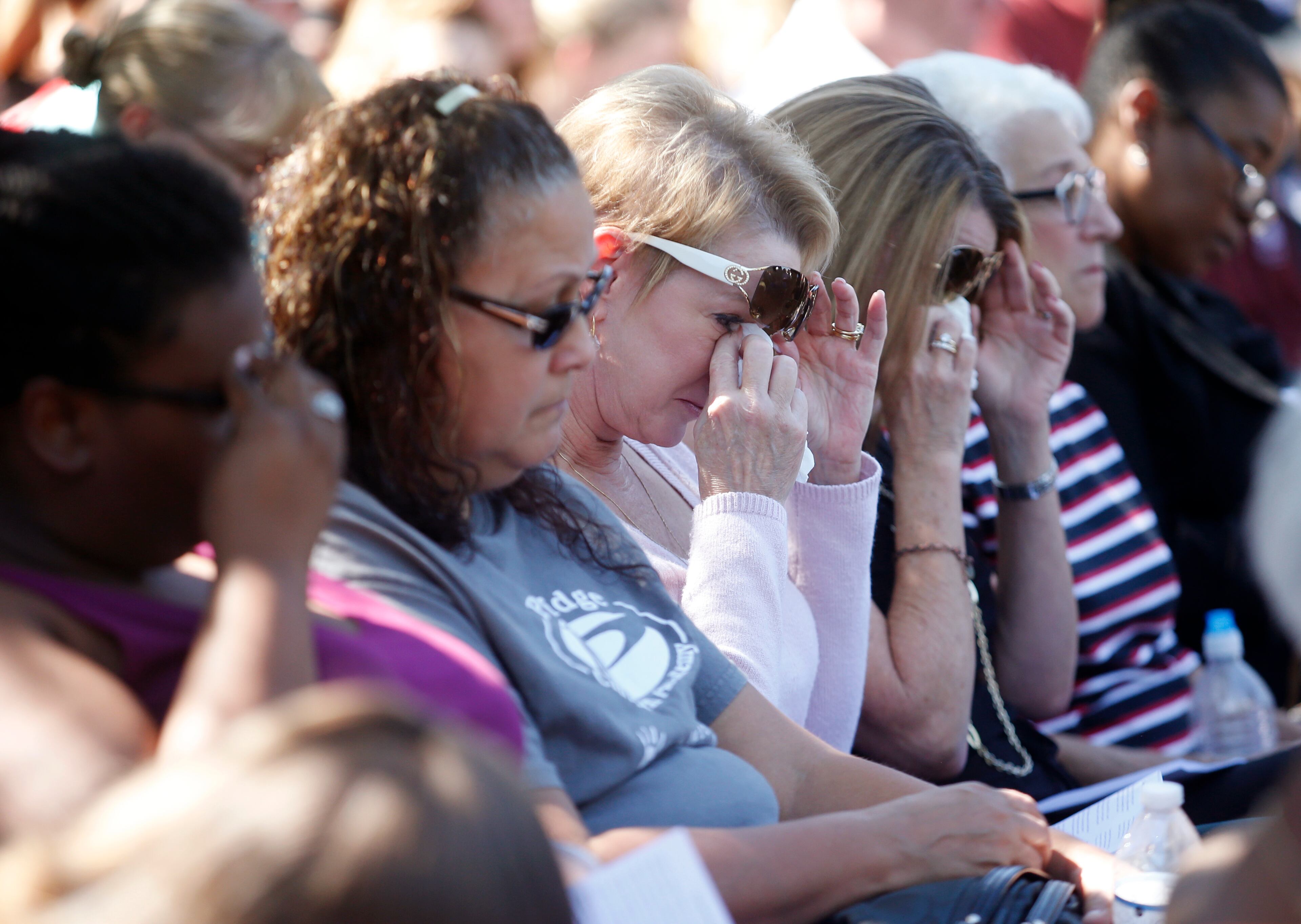 Attendees wipe their eyes during a prayer vigil for the victims of the shooting at Marjory Stoneman Douglas High School at the Parkland Baptist Church, Thursday, Feb. 15, 2018 in Parkland, Fla. Nikolas Cruz, a former student, was charged with 17 counts of premeditated murder Thursday morning. (AP Photo/Wilfredo Lee)