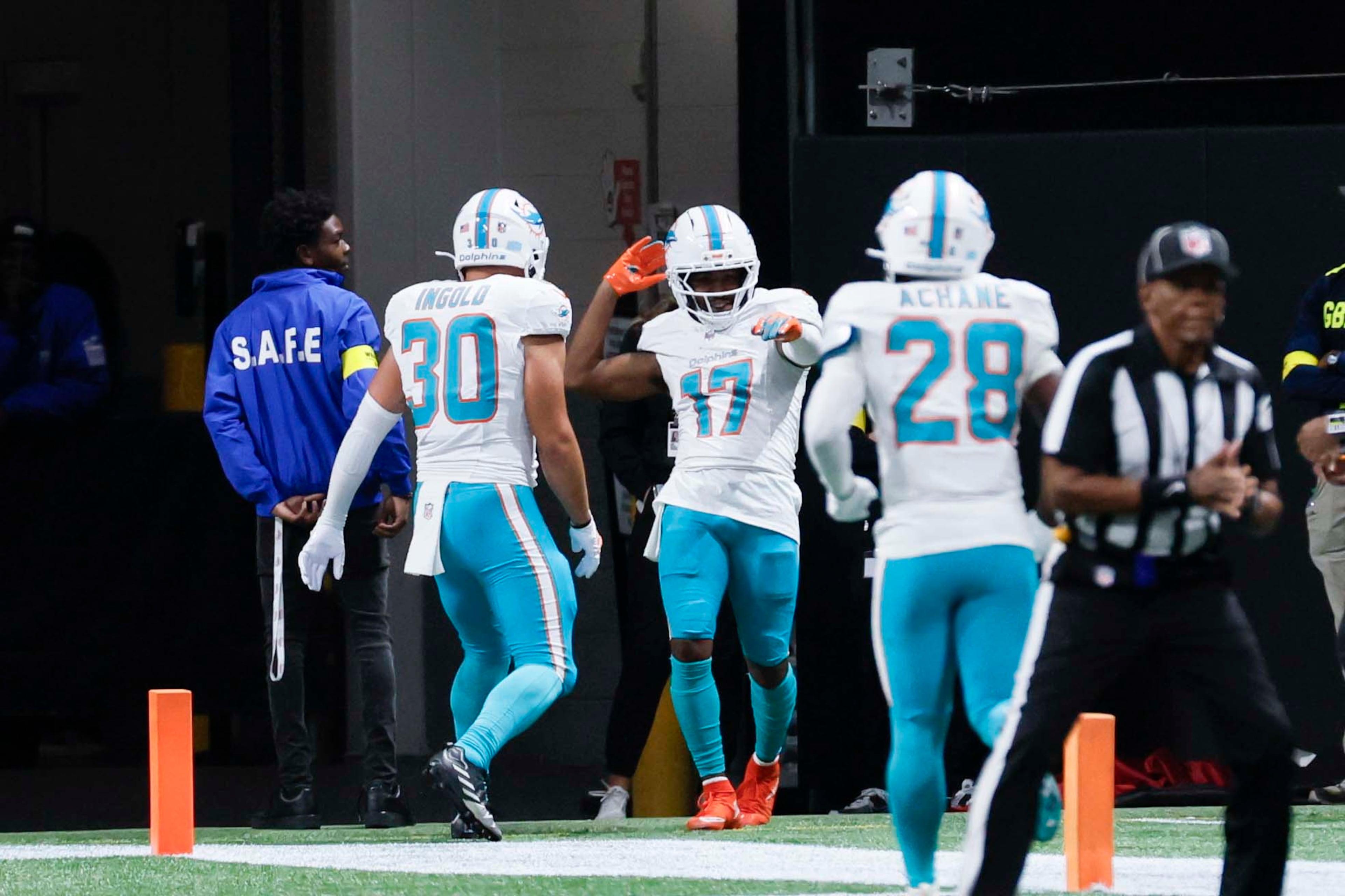 Miami Dolphins wide receiver Jaylen Waddle (center) celebrates with teammates after his touchdown during the second half of an NFL game against the Atlanta Falcons at Mercedes-Benz Stadium in Atlanta on Sunday, Oct. 26, 2025. (Miguel Martinez/AJC)
