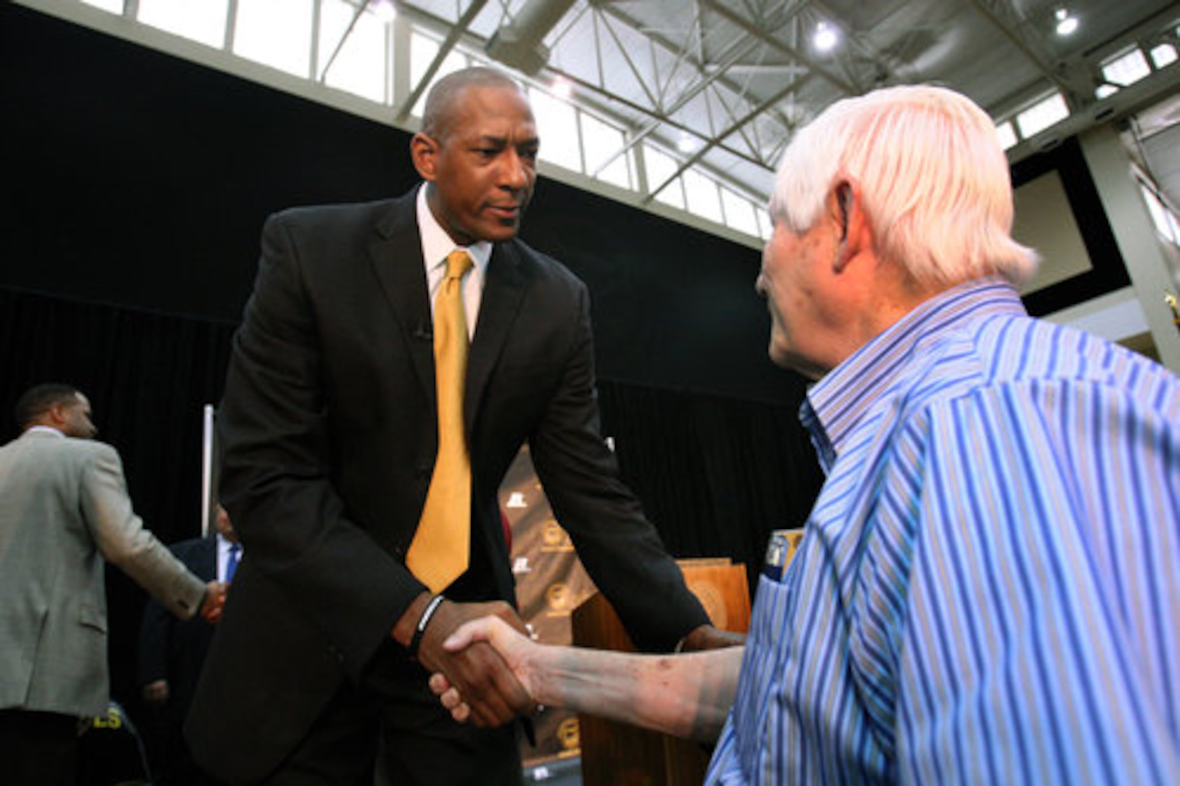 Coach Preston listens intently to a question from KSU staff member and KSU Booster Richard Allen, of Marietta, after Preston's first news conference. Preston has a background in academic improvement that the Owls need, which is something that KSU officials said helped his candidacy.