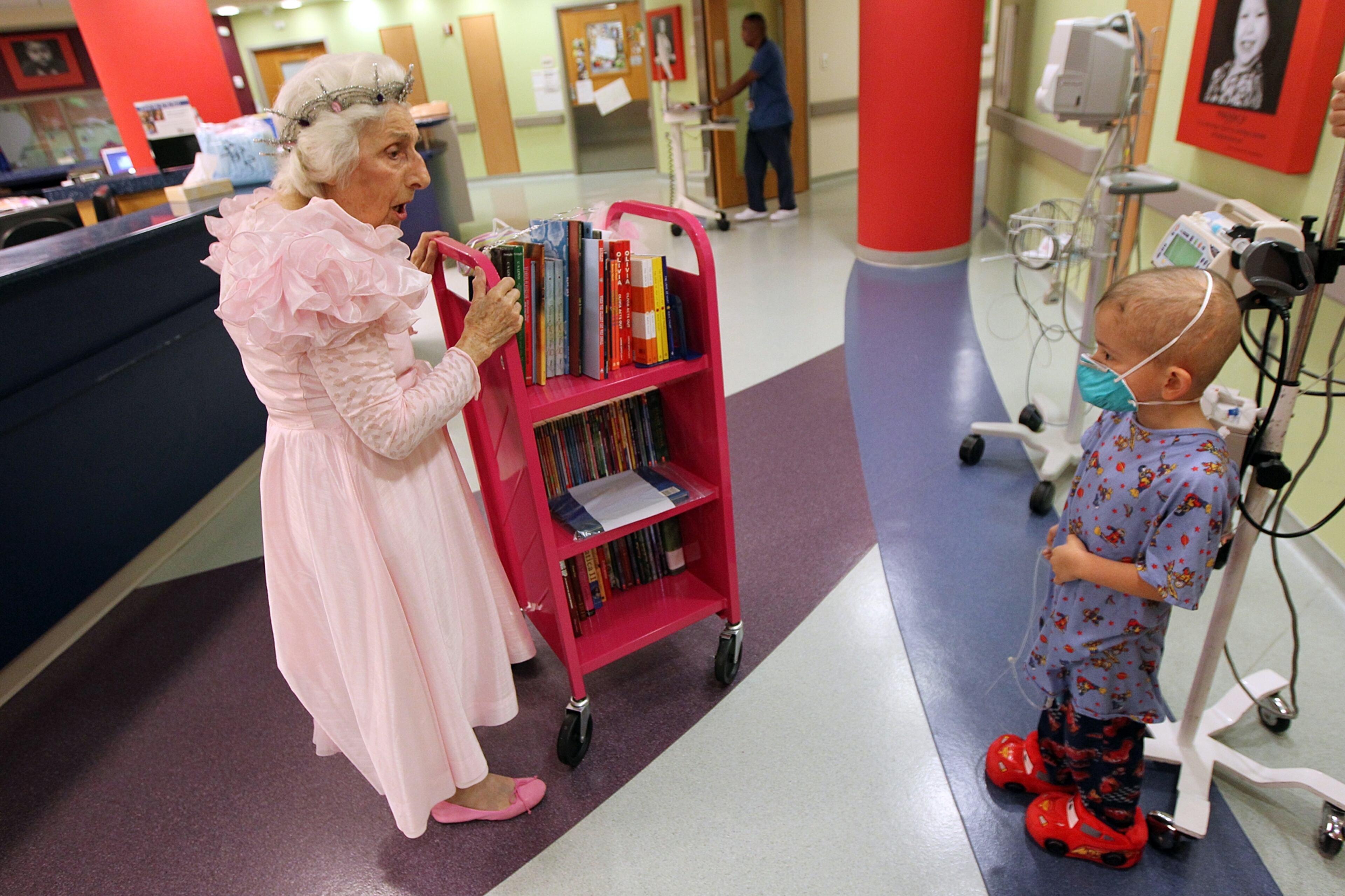 Kevin Romosalas, 5, Norcross, seems a bit surprised to run into Viener pushing a book cart through the blood and marrow transplant unit at Children's Healthcare on Aug. 28.