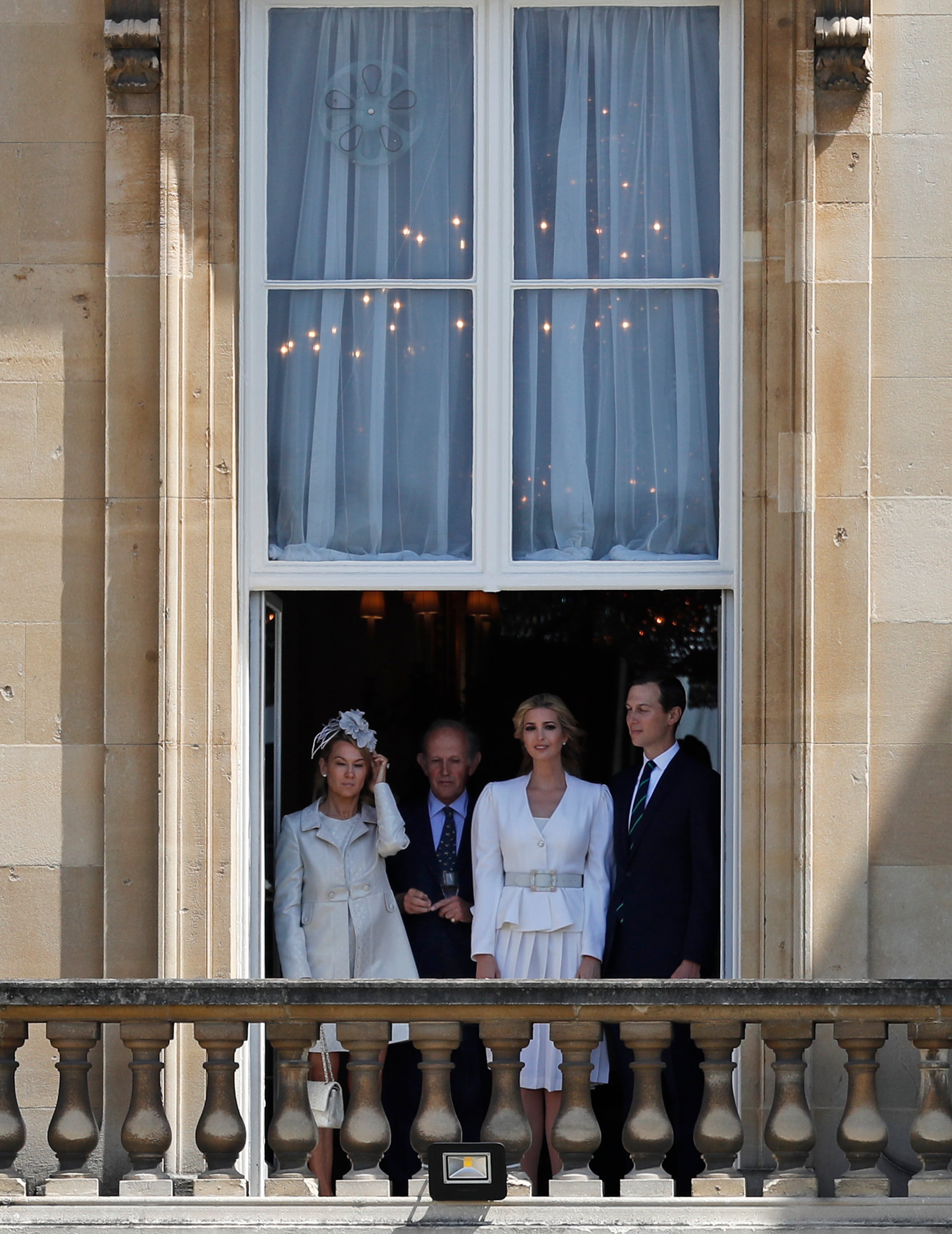 Jared Kushner, right, and Ivanka Trump, second right, watch from a window before a ceremonial welcome in the garden of Buckingham Palace in London for President Donald Trump and first lady Melania Trump, Monday, June 3, 2019 on the opening day of a three day state visit to Britain. (AP Photo/Matt Dunham)