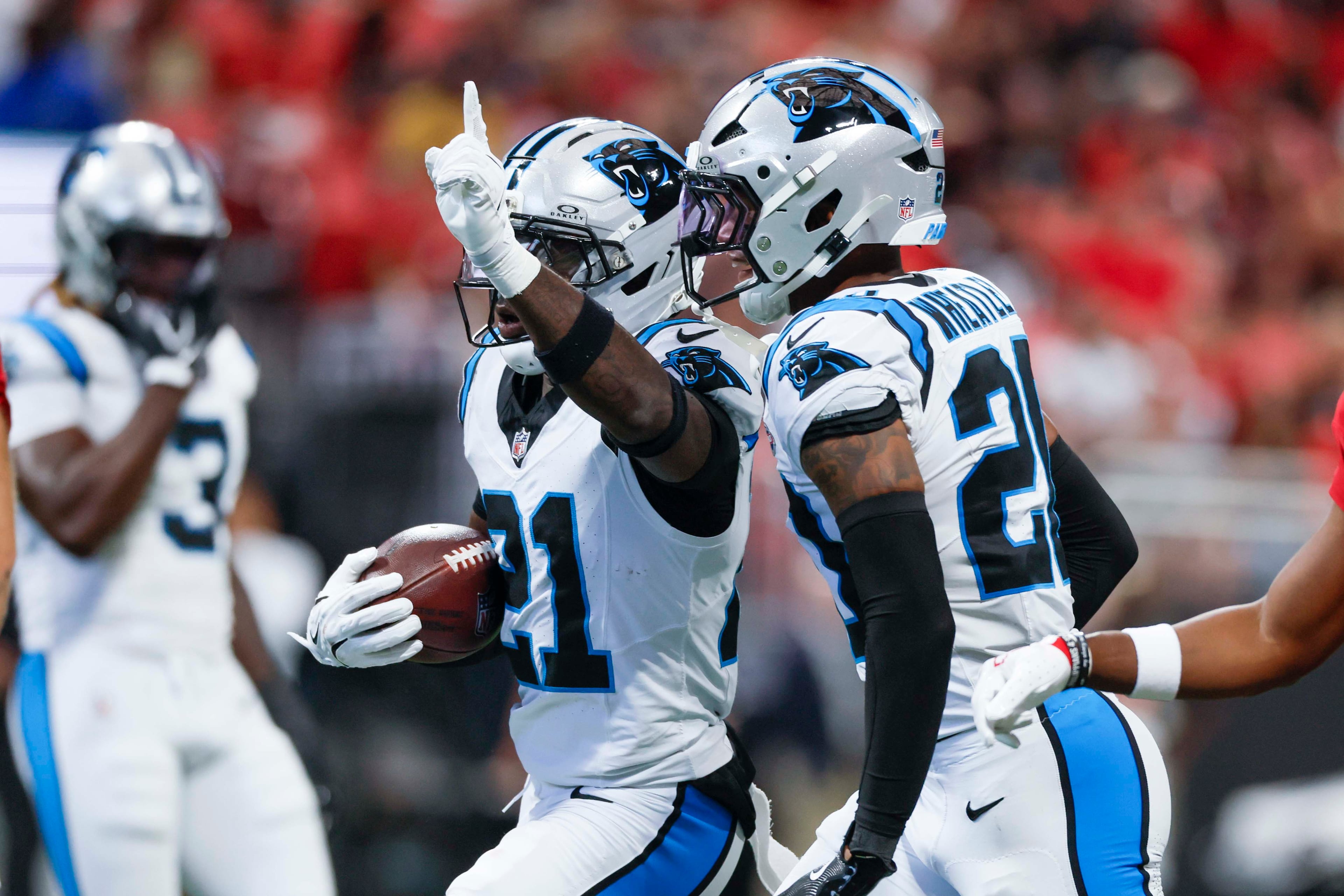 Carolina Panthers safety Nick Scott (21), left, celebrates after recovering a fumble during the first half of an NFL game against the Atlanta Falcons at Mercedes-Benz Stadium in Atlanta on Sunday, September 20, 2026. (Miguel Martinez/AJC)