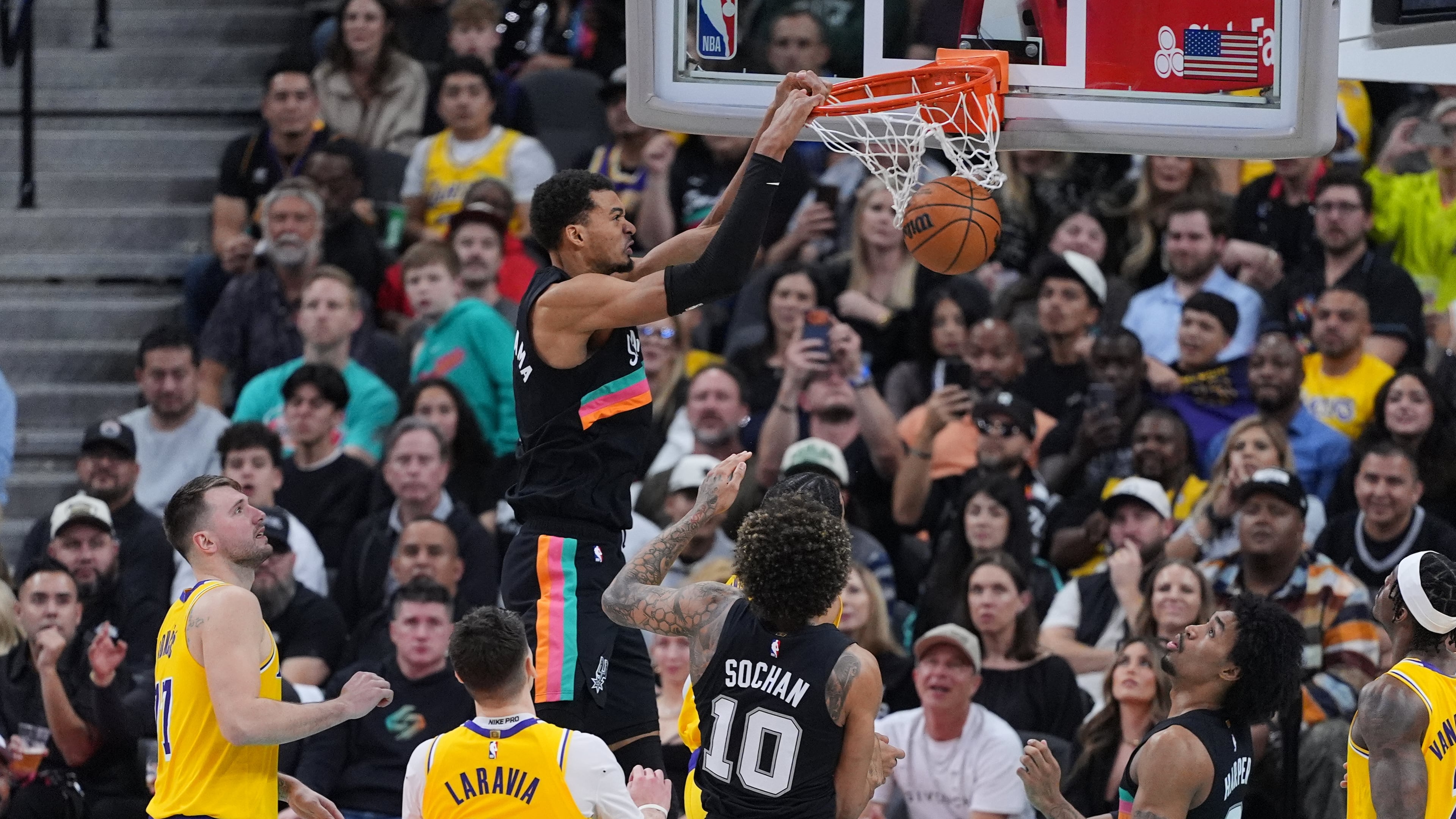 San Antonio Spurs forward Victor Wembanyama (1) scores against the Los Angeles Lakers during the second half of an NBA basketball game in San Antonio, Wednesday, Jan. 7, 2026. (AP Photo/Eric Gay)