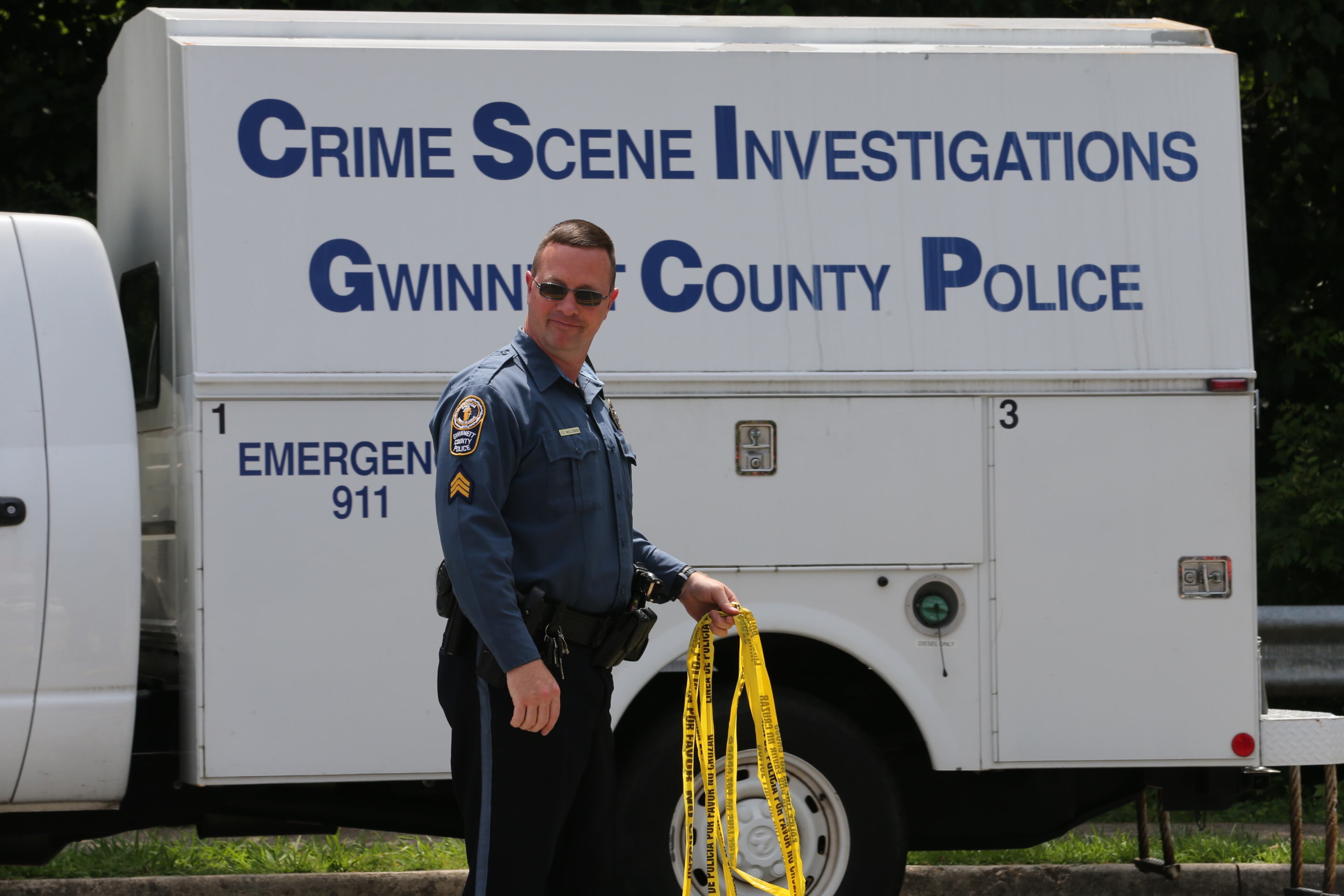 A Gwinnett Police officer shot and killed a suspected bank robber Monday morning after the suspect pistol whipped him during a struggle behind a nearby church, officials said. JOHN SPINK/JSPINK@AJC.COM
