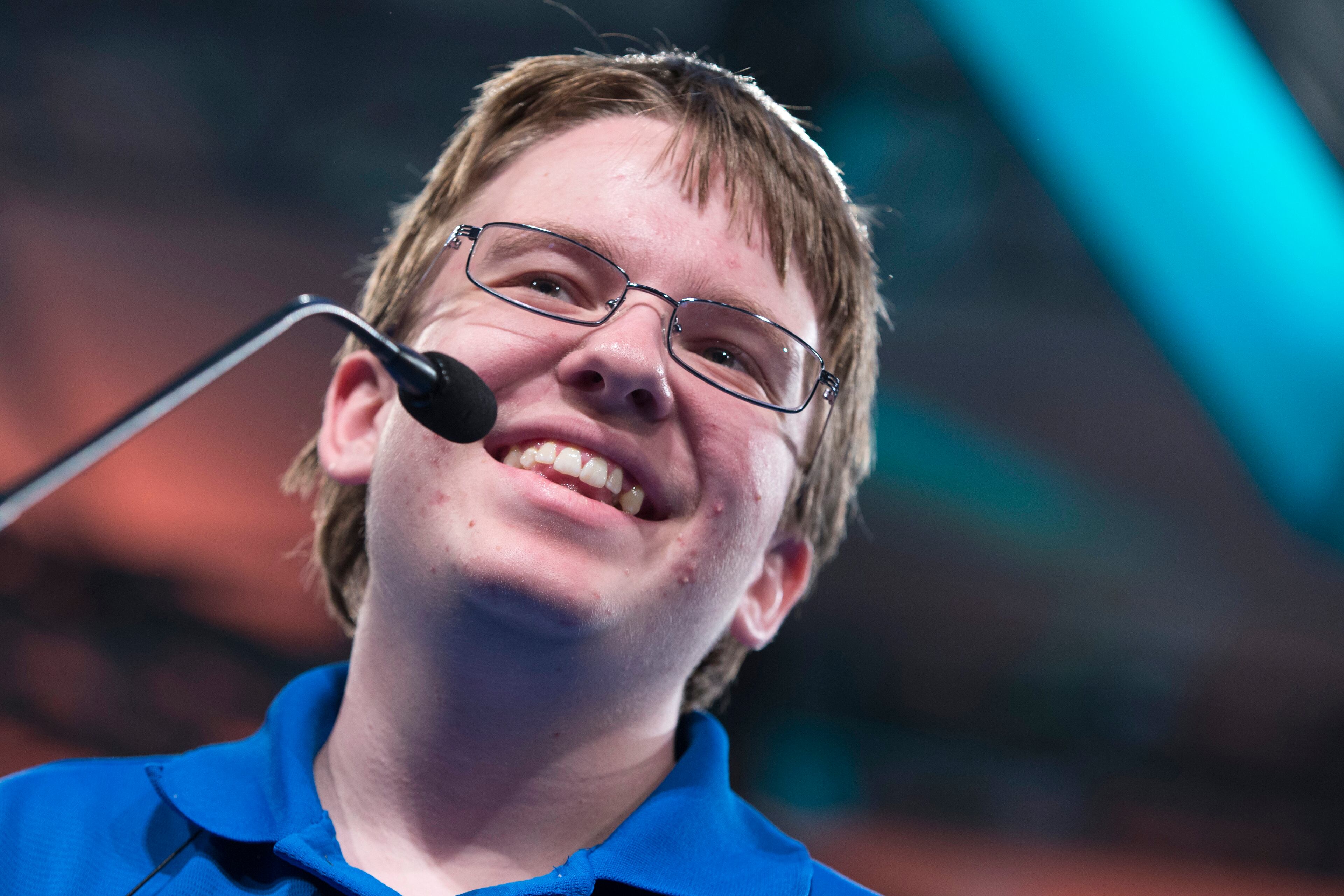 Jacob Williamson of Cape Coral, Fla., smiles before spelling the word "impasto" during the preliminary round of the National Spelling Bee, Wednesday, May 28, 2014, in Oxon Hill, Md. (AP Photo/ Evan Vucci)
