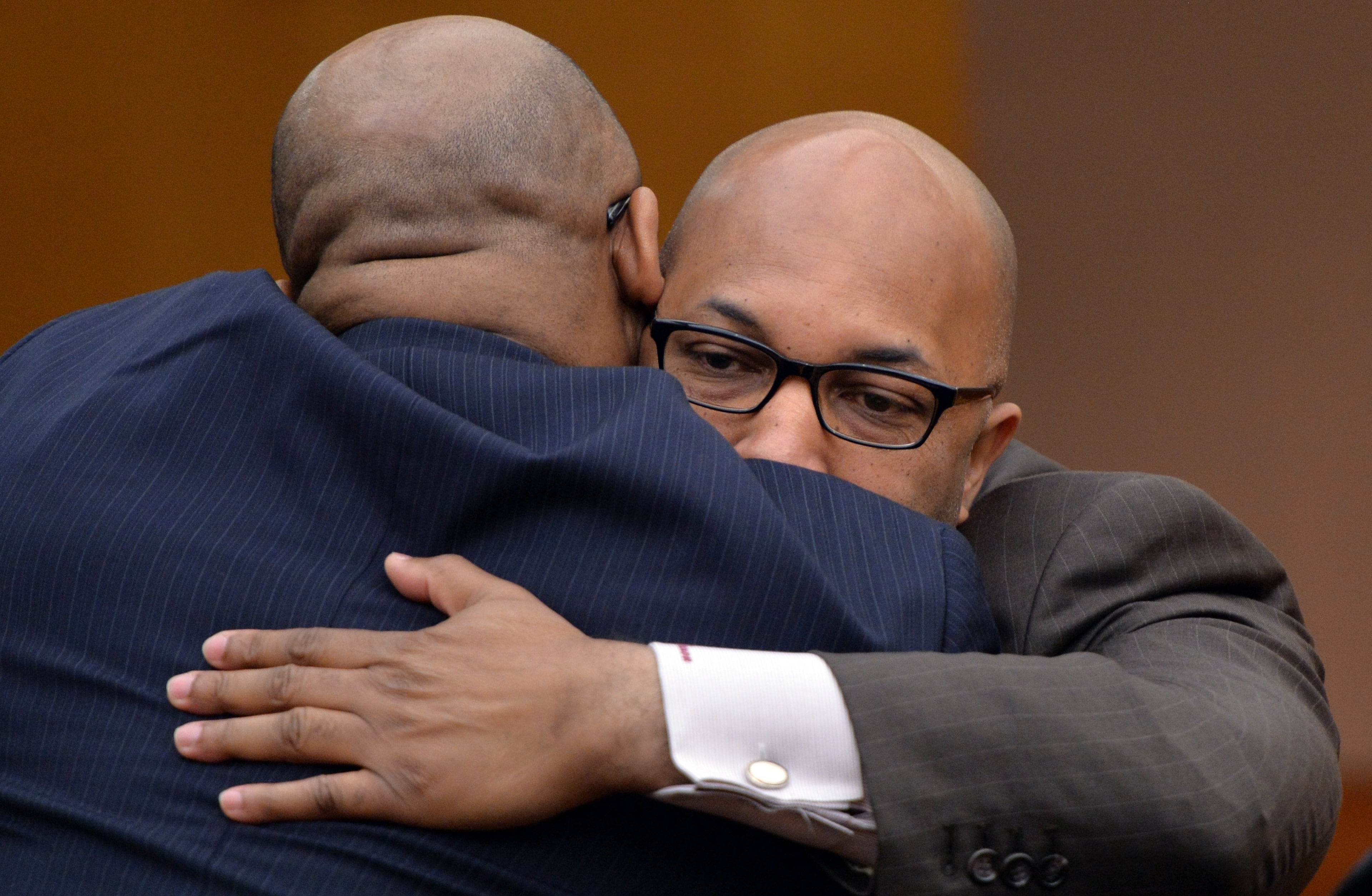 Lucious Brown (right), former principal of Kennedy Middle School, and prosecutor Clint Rucker, hug after his plea hearing on Friday, January 17, 2014. Lucious Brown on Friday became the third principal to plead guilty in the Atlanta Public Schools test-cheating scandal. Brown, who once headed Kennedy Middle School, pleaded guilty to a single felony count before Fulton County Superior Court Judge Jerry Baxter. HYOSUB SHIN / HSHIN@AJC.COM