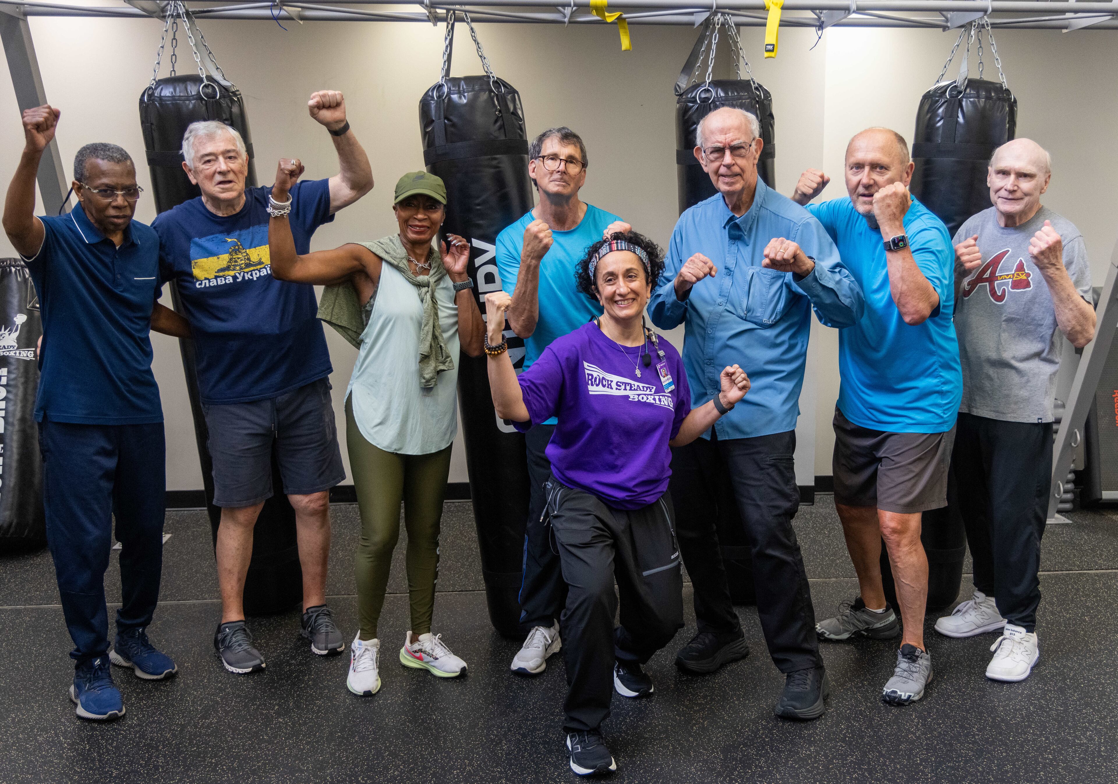 Rock Steady Boxing Instructor Nausheen Quraishy(center, foreground) poses with her class at Wellstar Health Place on the campus of Kennestone Hospital. She runs an exercise class for people who have been diagnosed with Parkinson's disease. Quraishy also has had severe health problems. She had a brain bleed 18 years ago and was stripped of her early memories. She and her students are doing all they can to help themselves. The students are fighting to try to delay the progression of their disease. PHIL SKINNER FOR THE ATLANTA JOURNAL-CONSTITUTION