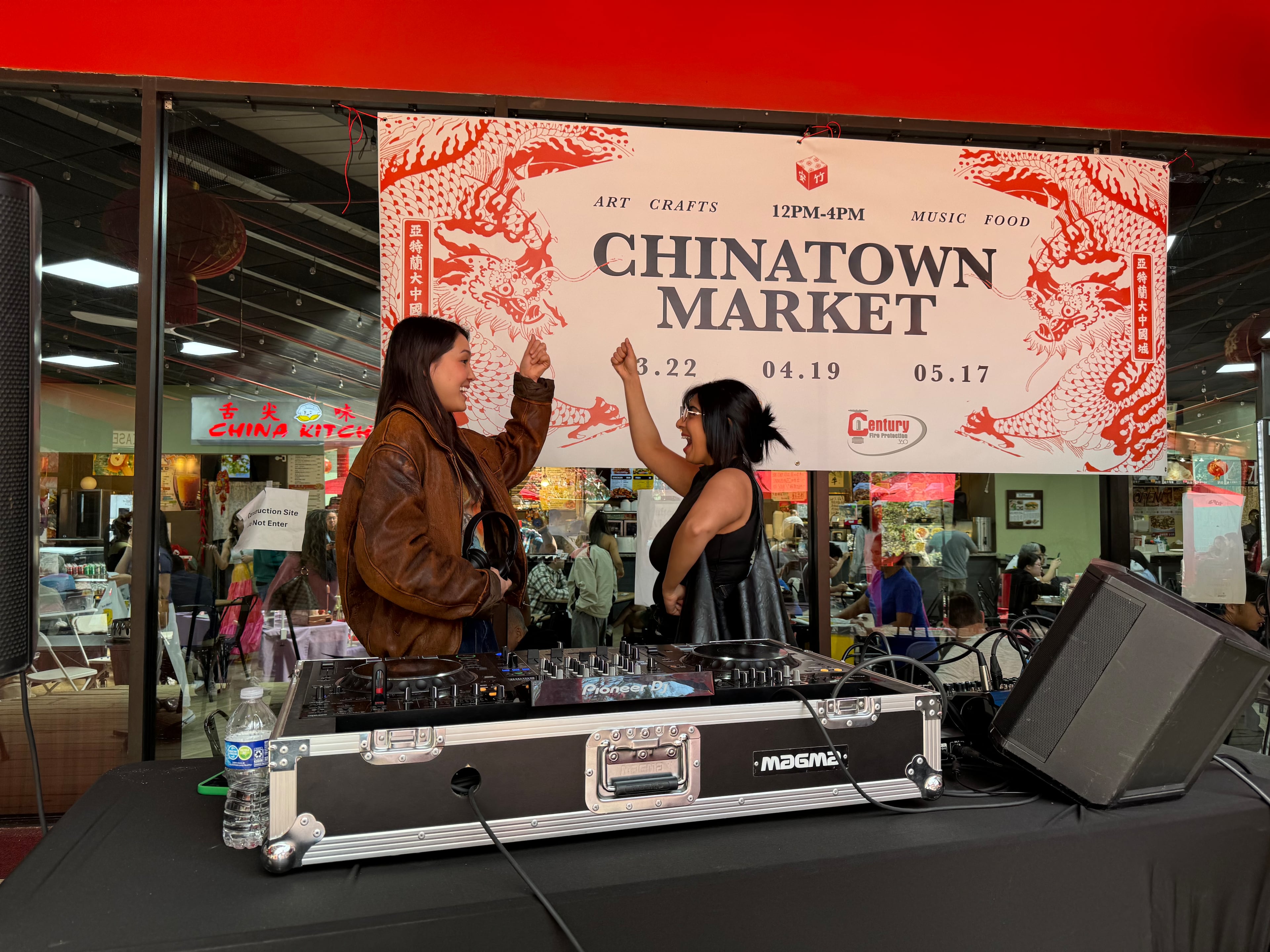 DJ Susie Kim (left) played electronic dance music at last month’s Blooms Chinatown Market and was joined onstage by her friend, Ayesha Ahuja. (Phil Kloer for the AJC)
