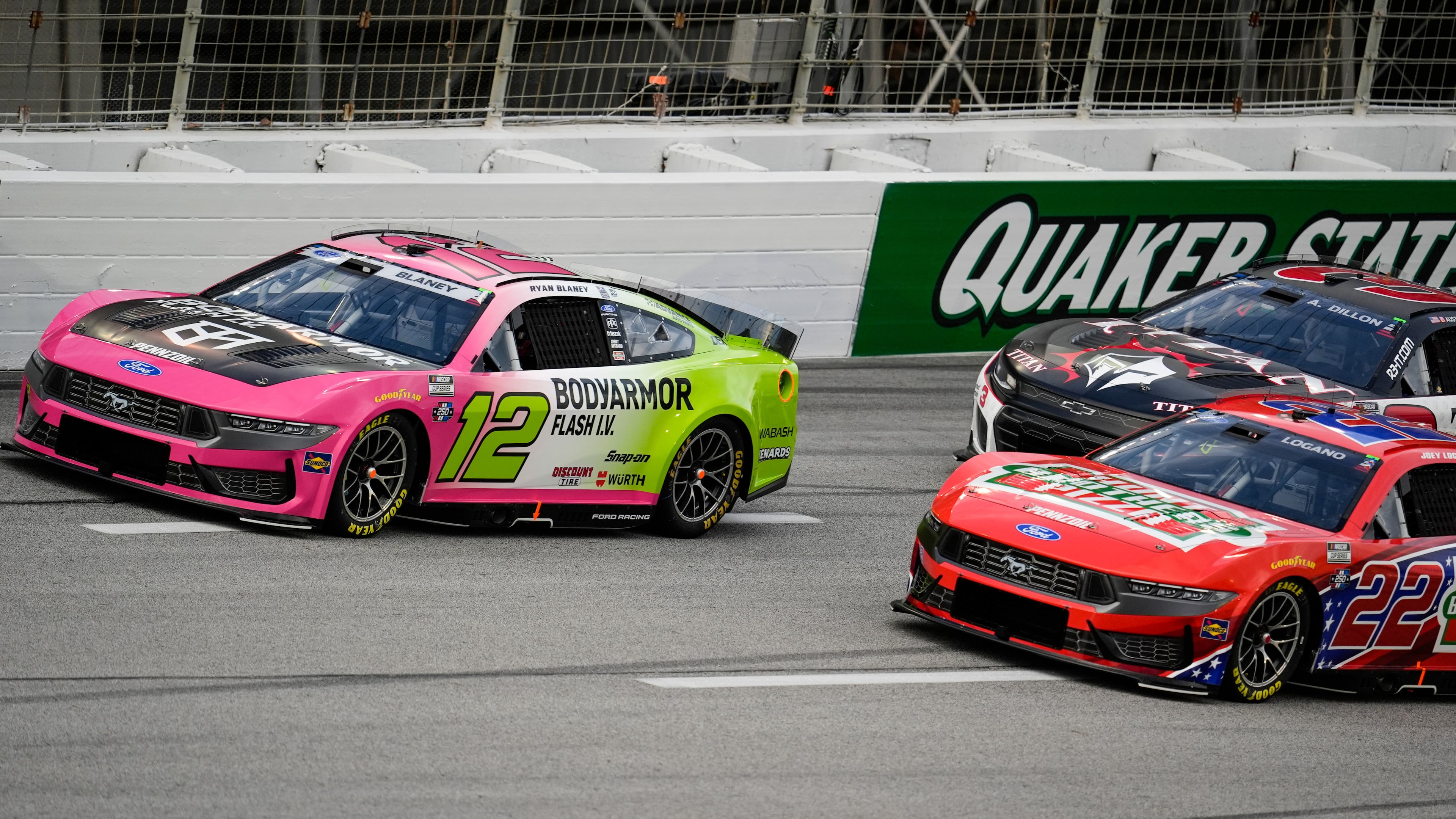 Ryan Blaney (12) and Joey Logano (22) run during a NASCAR Cup Series auto race, Sunday, July 12, 2026, in Hampton, Ga. (AP Photo/Mike Stewart)