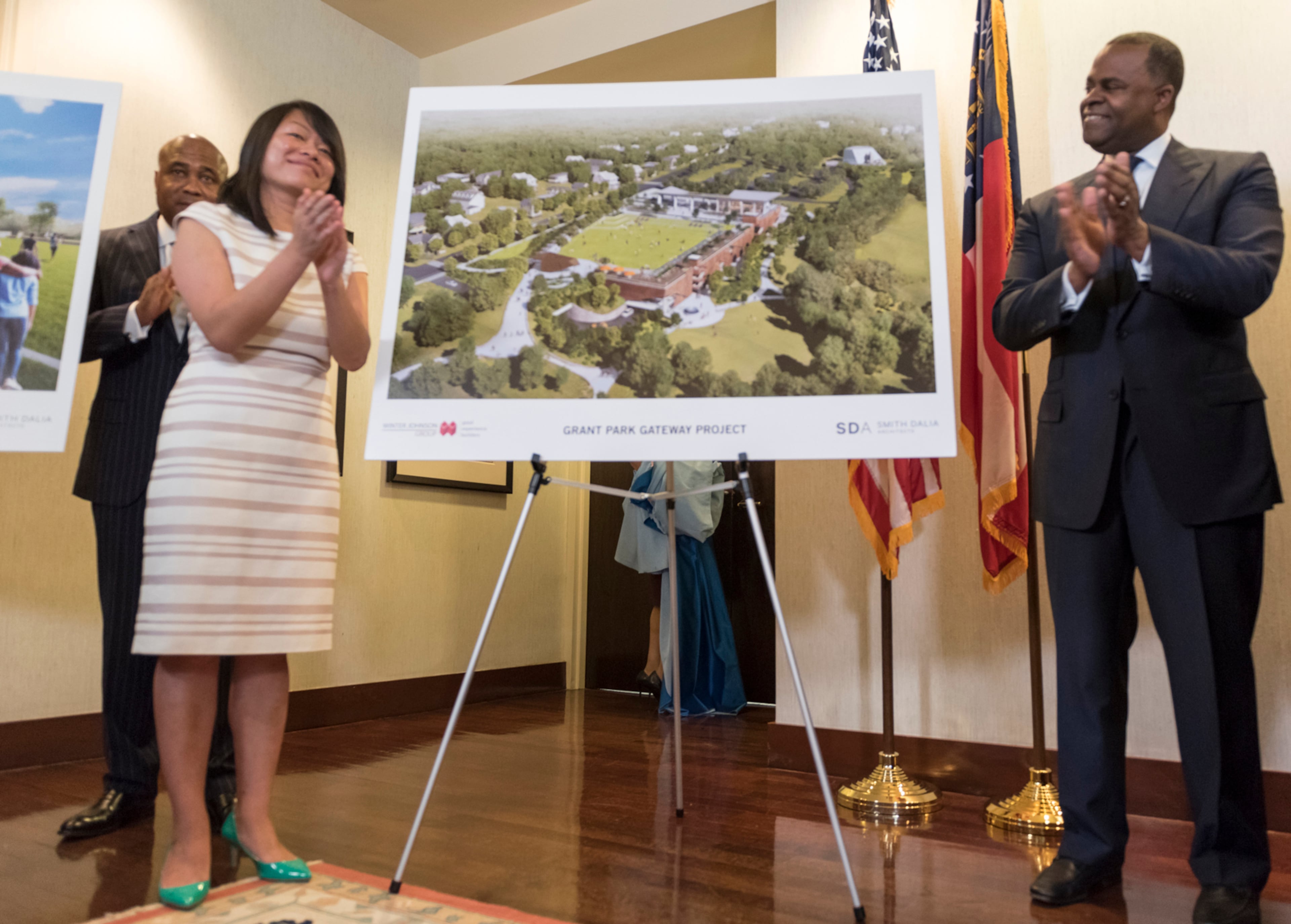 April 25, 2017 - Mayor Kasim Reed and Amy Phuong, Commissioner of Department of Parks and Recreation, left, applaud after revealing renderings of the Grant Park Gateway Project during a press conference. The Grant Park Gateway Project aims to alleviate traffic and address a lack of parking.