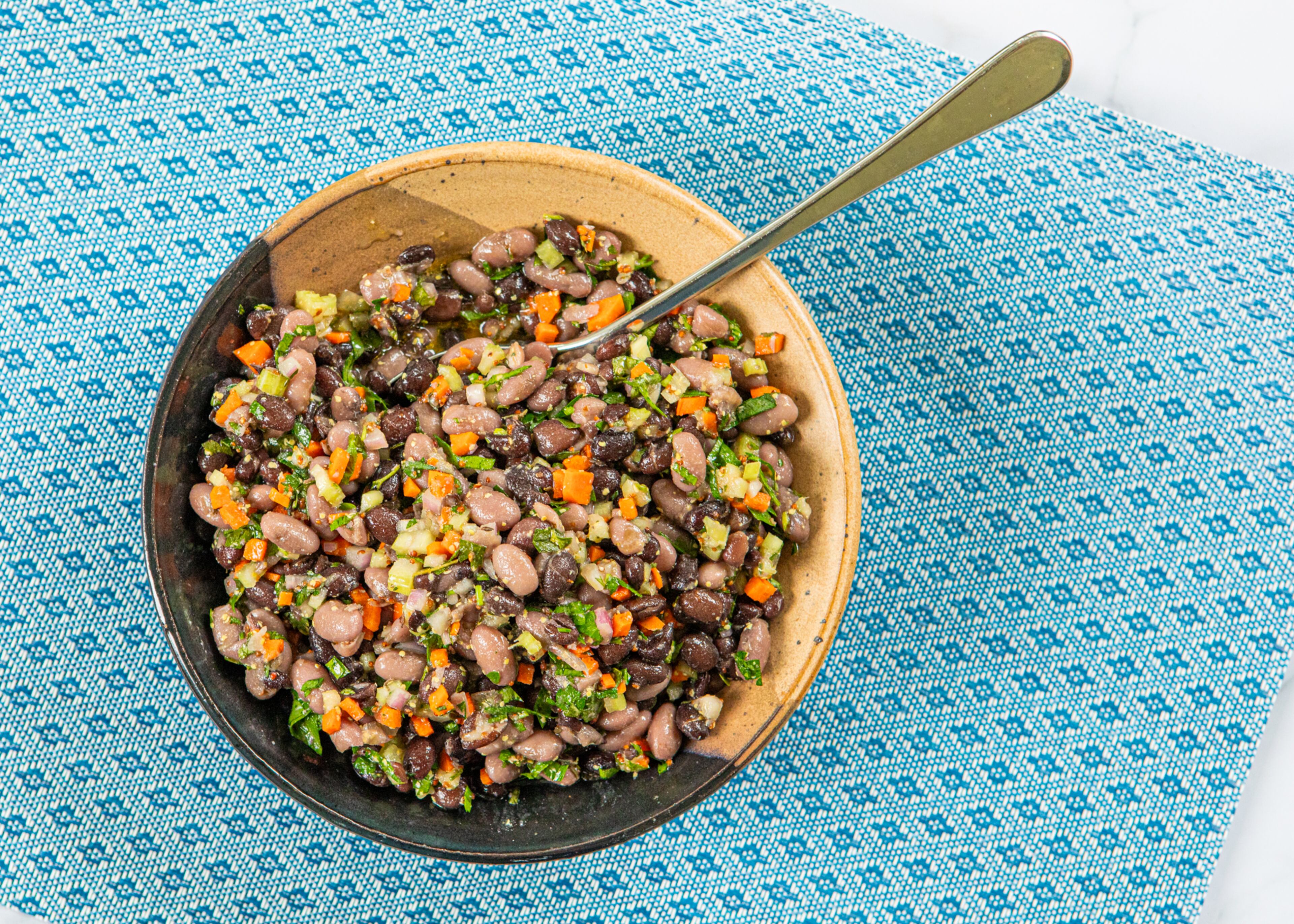 Salads are a delicious way to use up leftover beans. This recipe for Mustardy Bean Salad is inspired by a traditional French lentil salad. (Aaliyah Man for the AJC/food styling by Kate Williams)