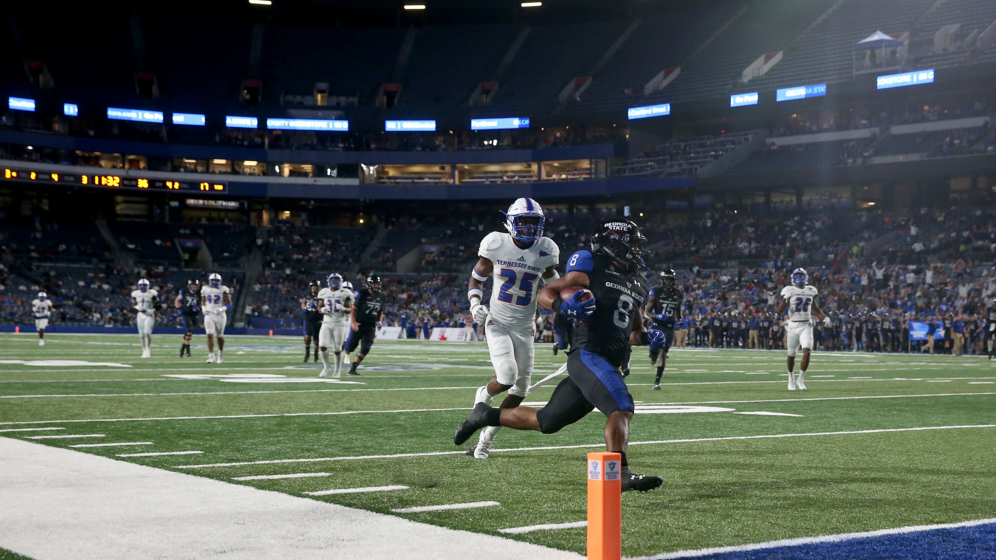 Georgia State Panthers running back Taz Bateman (8) scores a touchdown against Tennessee State Tigers defensive back Vincent Sellers (25) during the second half at Georgia State Stadium Thursday in Atlanta, Ga., August 31, 2017. PHOTO / JASON GETZ