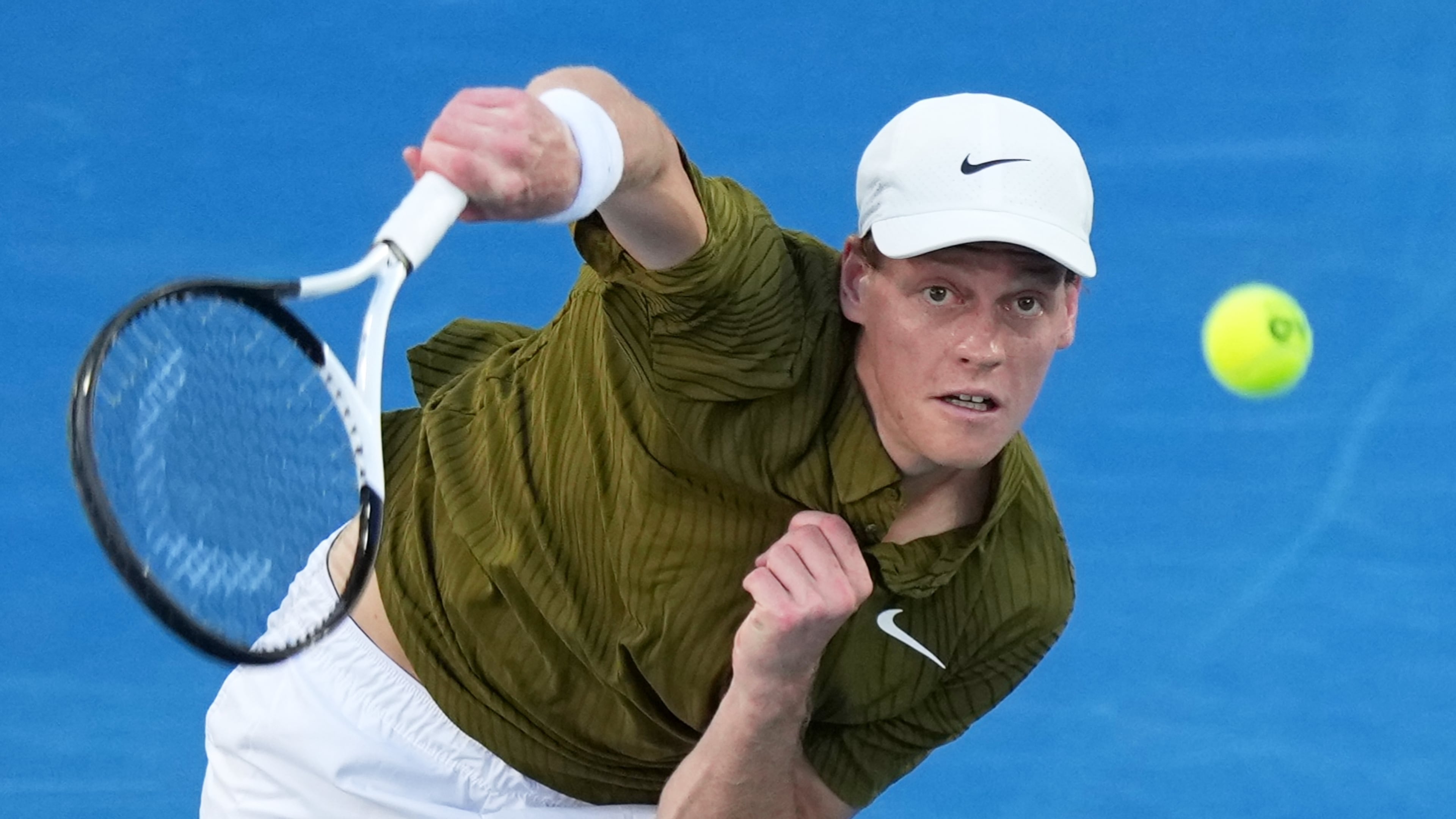 Jannik Sinner of Italy serves to his compatriot Luciano Darderi during their fourth round match at the Australian Open tennis championship in Melbourne, Australia, Monday, Jan. 26, 2026. (AP Photo/Aaron Favila)