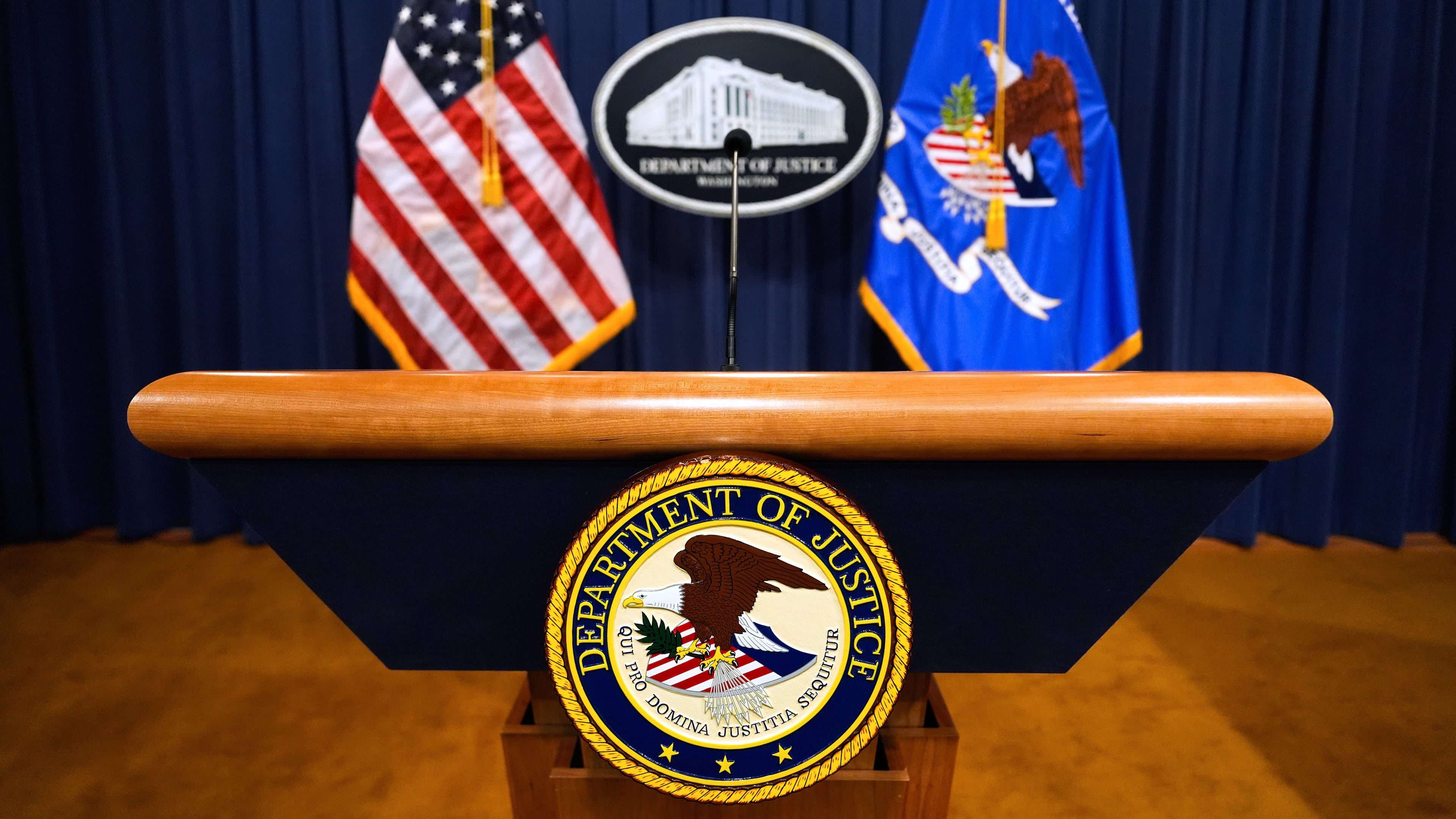 FILE - The U.S. Department of Justice logo is seen on a podium before a press conference, May 6, 2025, at the Justice Department in Washington. (AP Photo/Julia Demaree Nikhinson, File)
