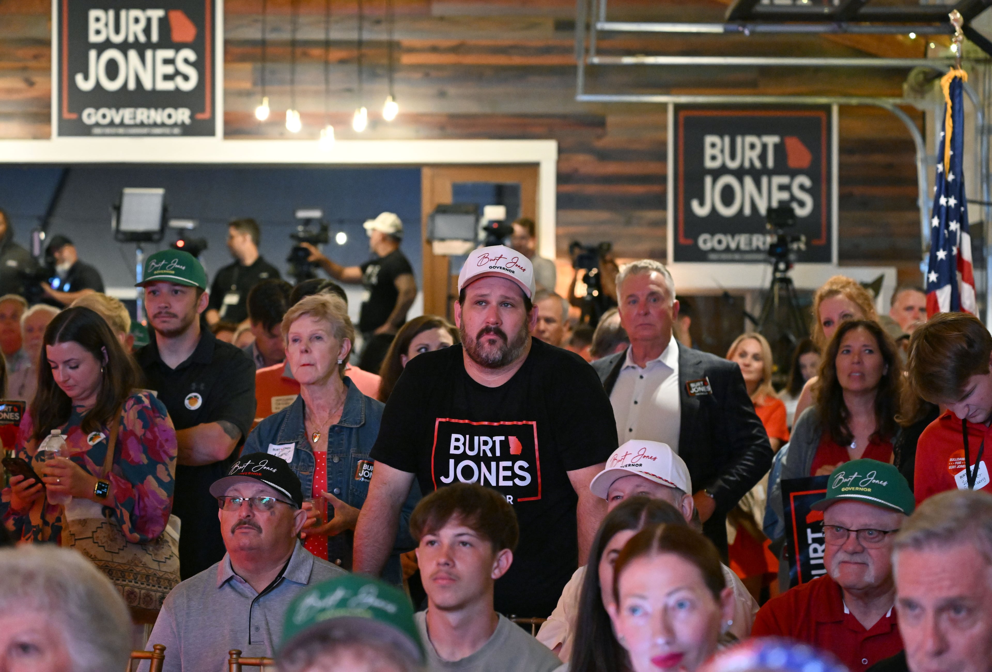 Supporters react as they watch election results on screens during an election night watch party for Georgia gubernatorial candidate Burt Jones at The Rivers Ranch during Georgia’s primary runoff on Tuesday, June 16, 2026, in Jackson. (Hyosub Shin/AJC)