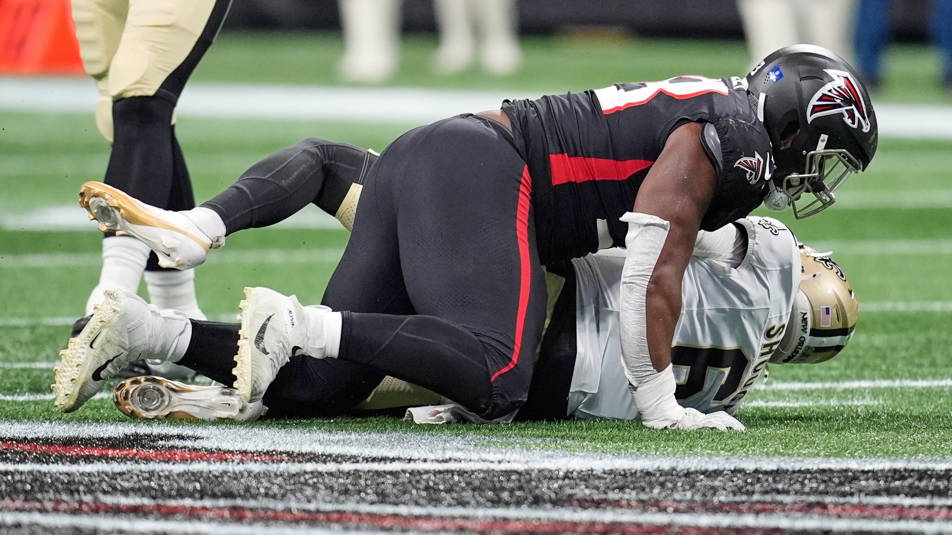 New Orleans Saints quarterback Tyler Shough is sacked by Atlanta Falcons defensive tackle Kentavius Street in the first half of an NFL football game, Sunday, Jan. 4, 2026, in Atlanta. (Mike Stewart/AP)