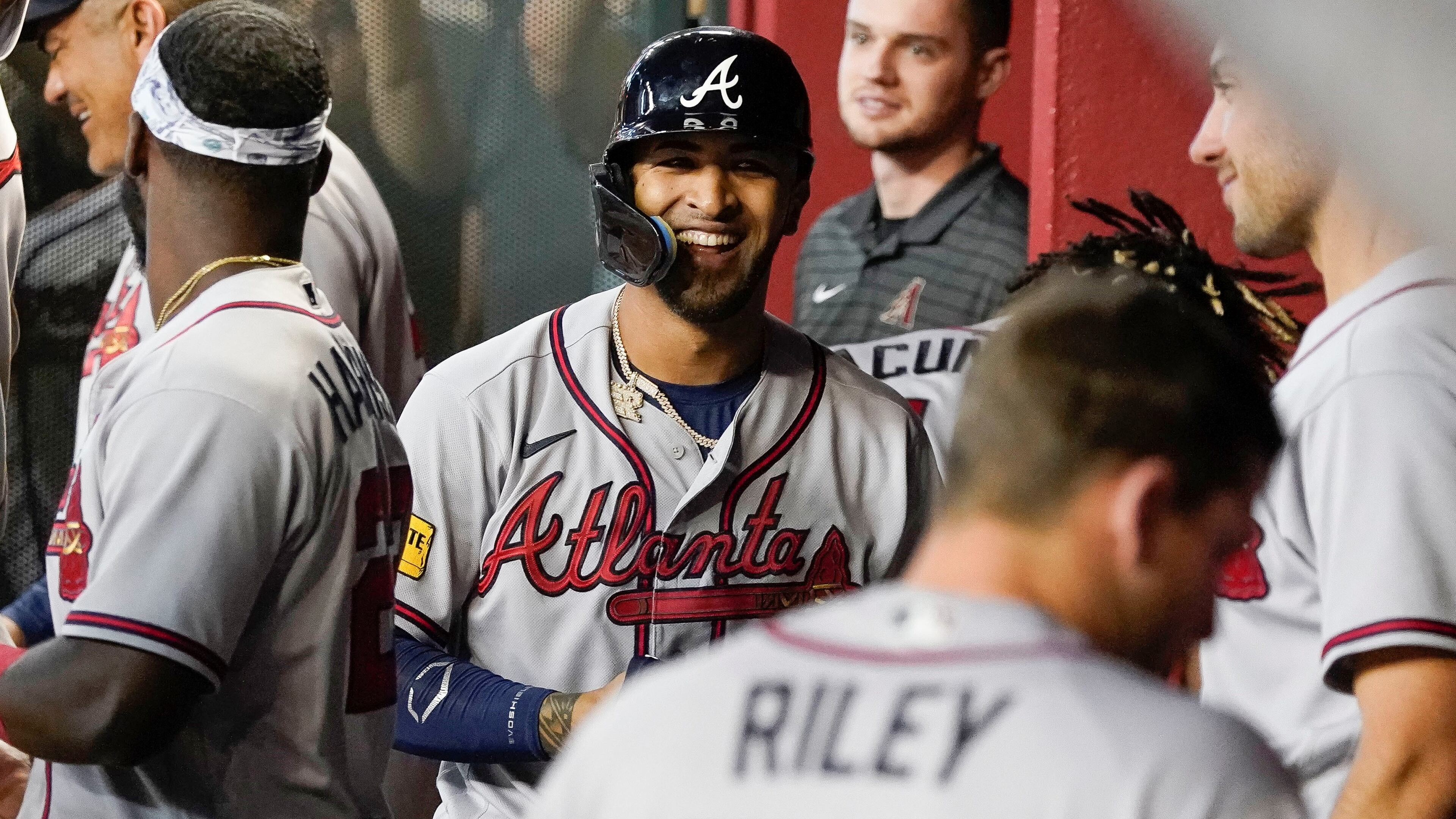 Eddie Rosario smiles in the dugout after his grand slam against the Arizona Diamondbacks during the ninth inning of a baseball game, Sunday, June 4, 2023, in Phoenix. (AP Photo/Darryl Webb)