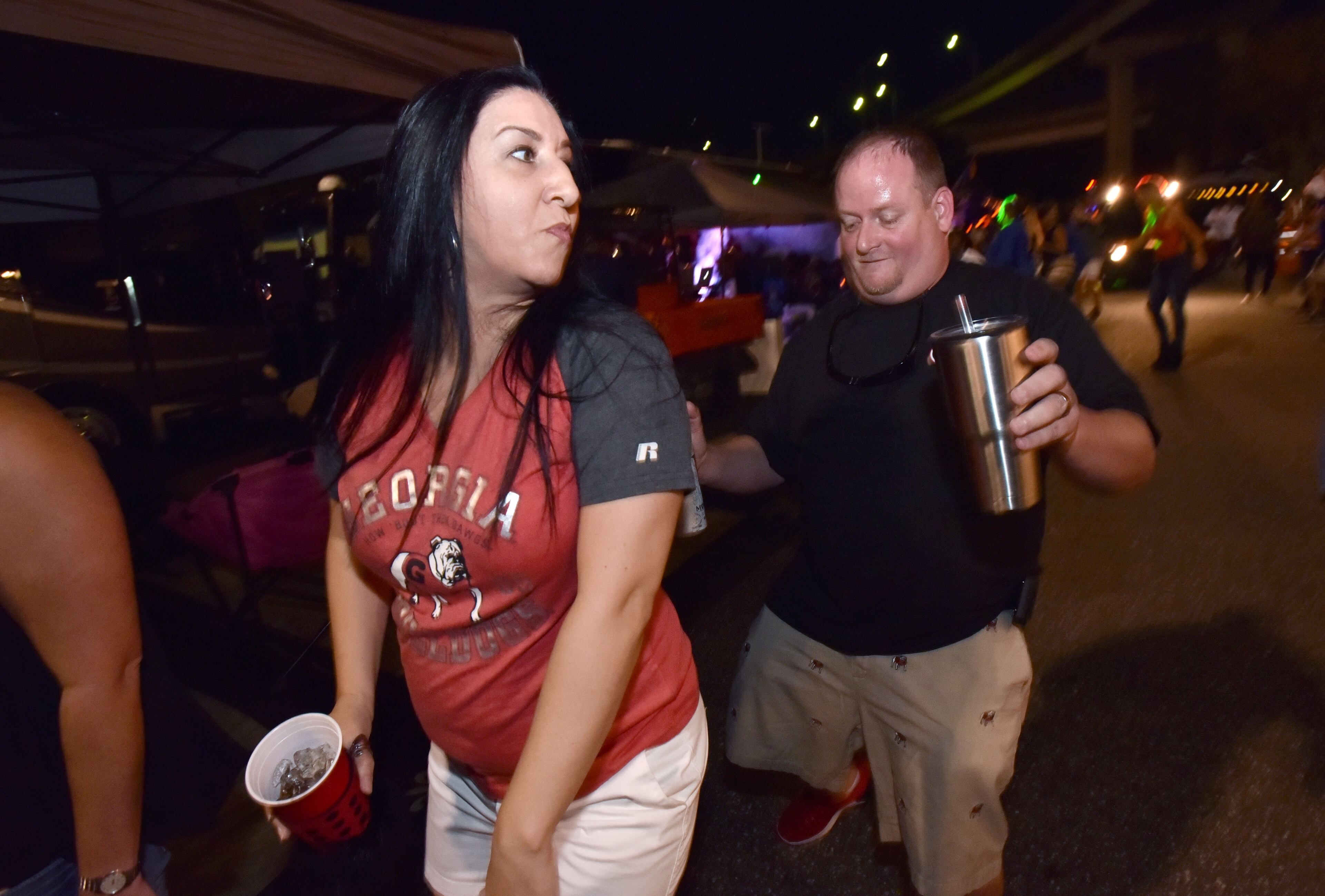 October 28, 2016 Jacksonville, Fla. - Georgia fans Christina and Mike Honsby dance as fans get ready for the Georgia vs Florida game at RV City in Jacksonville on Friday, October 28, 2016. HYOSUB SHIN / HSHIN@AJC.COM