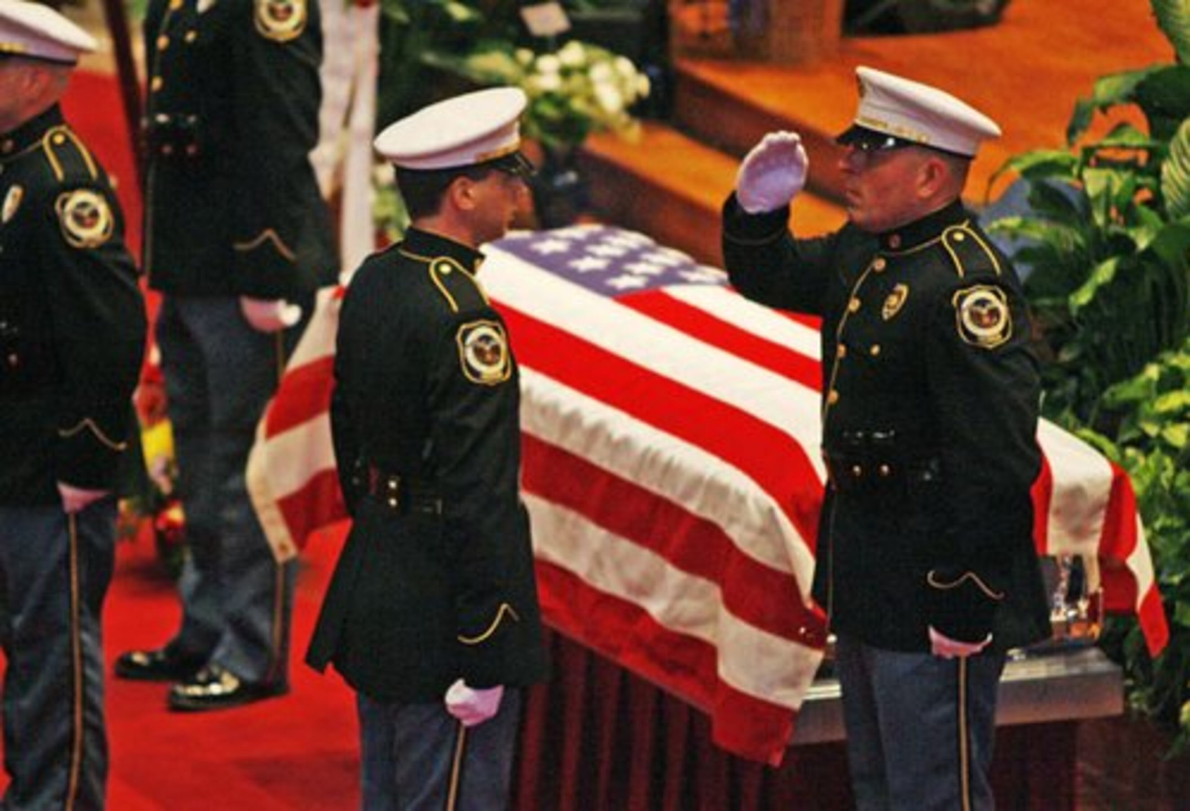 Cobb Police honor guard members salute during the service.