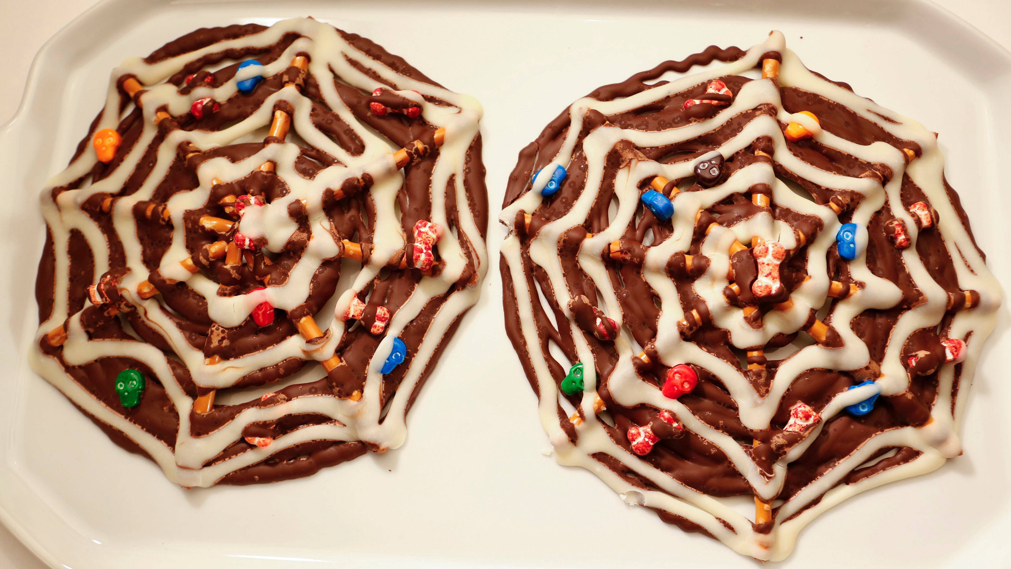 Arrange pretzel sticks in a pattern similar to the spokes on a wheel, then decorate with melted chocolate and Halloween candies. A great project for the little kids. (Anne Cusack/Los Angeles Times/MCT)