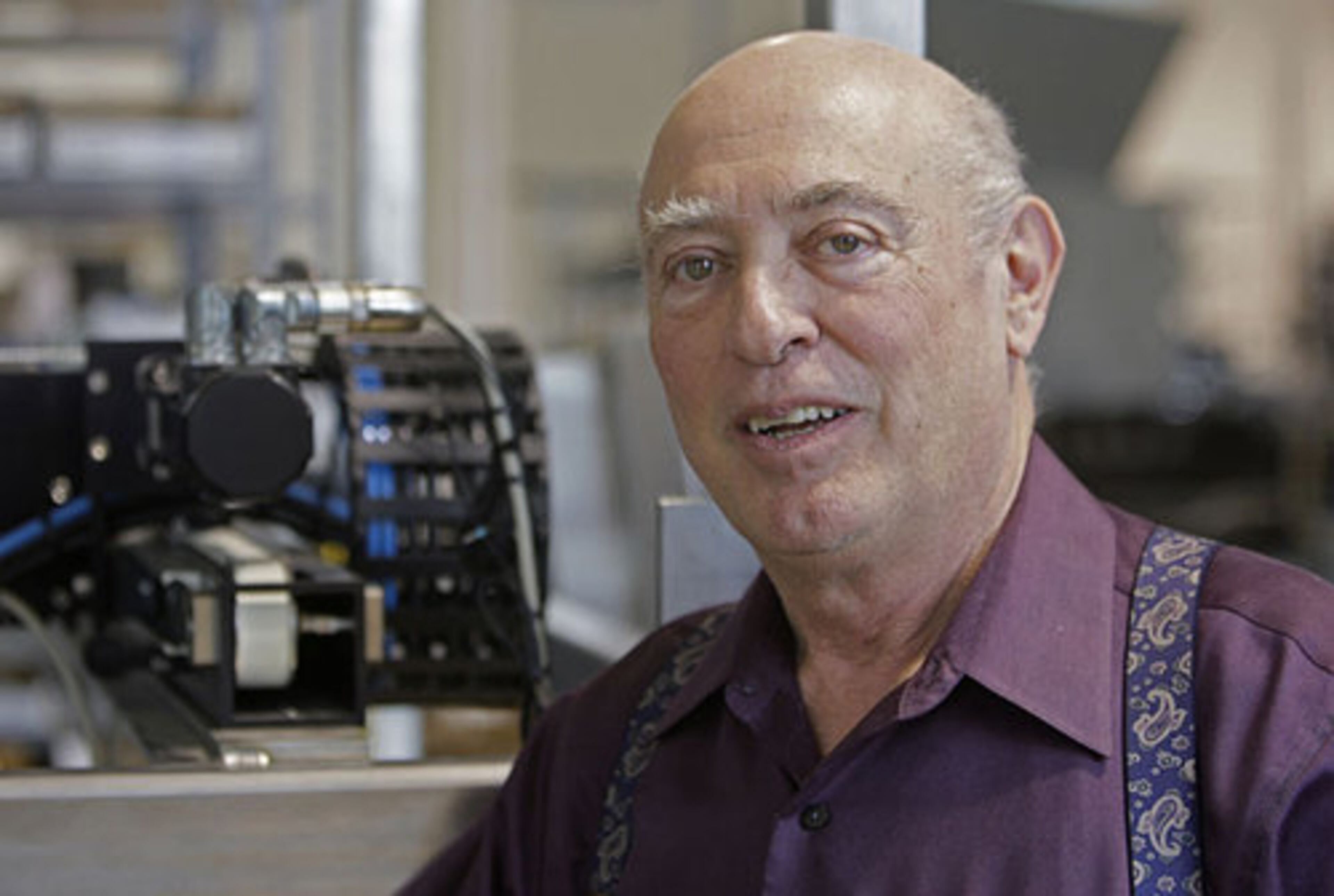 Company Chairman Steve Dickerson, with a portion of the CRP Robot, or "Case Ready Packer." The founders of CAMotion, a robotics company, believe Tech's presence could be a key engine to reversing the trade deficit's drain on America.