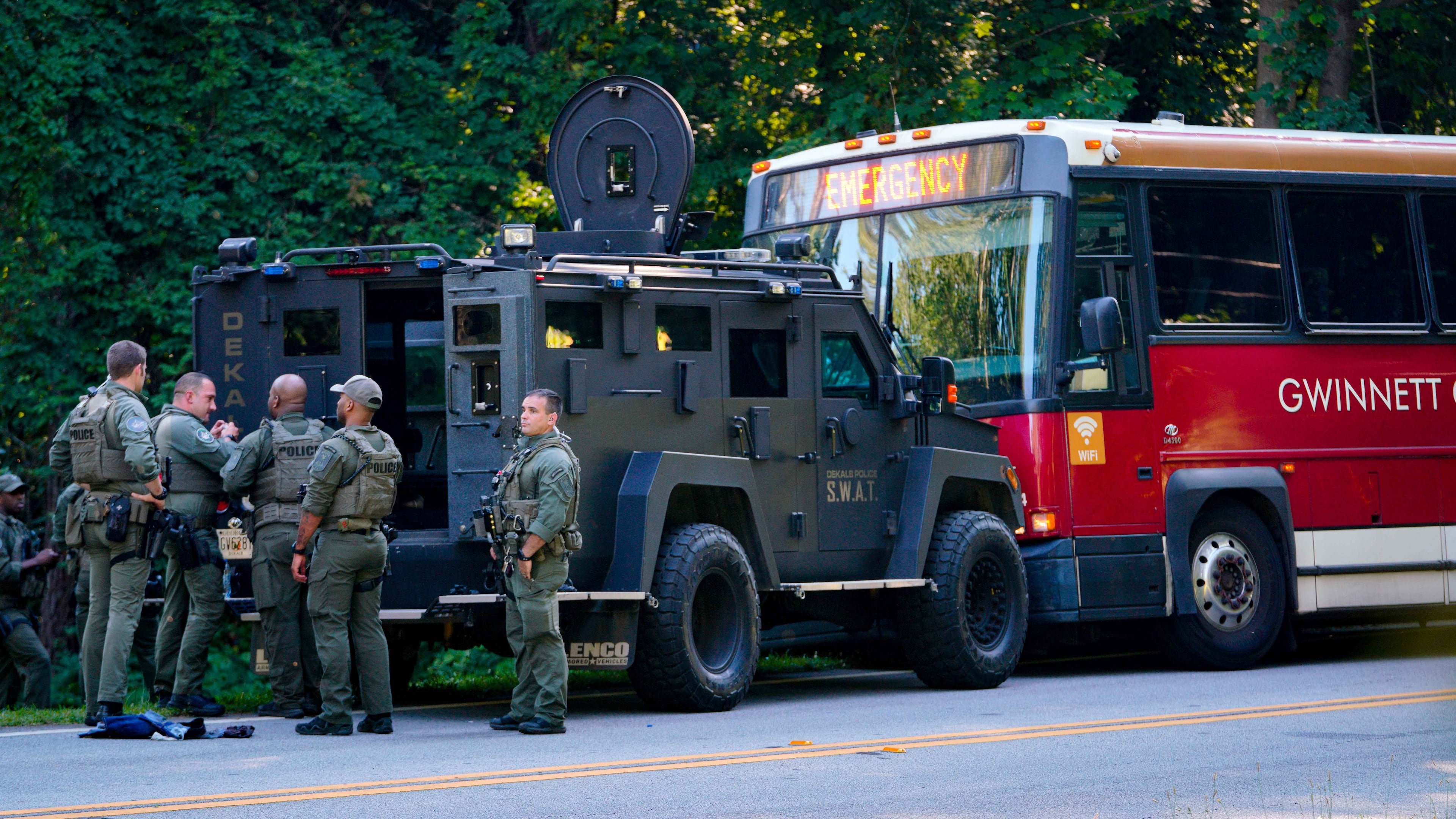 A Dekalb County SWAT vehicle is seen blocking the bus involved in the police chase and hostage situation. (Ben Hendren for The Atlanta Journal-Constitution)
