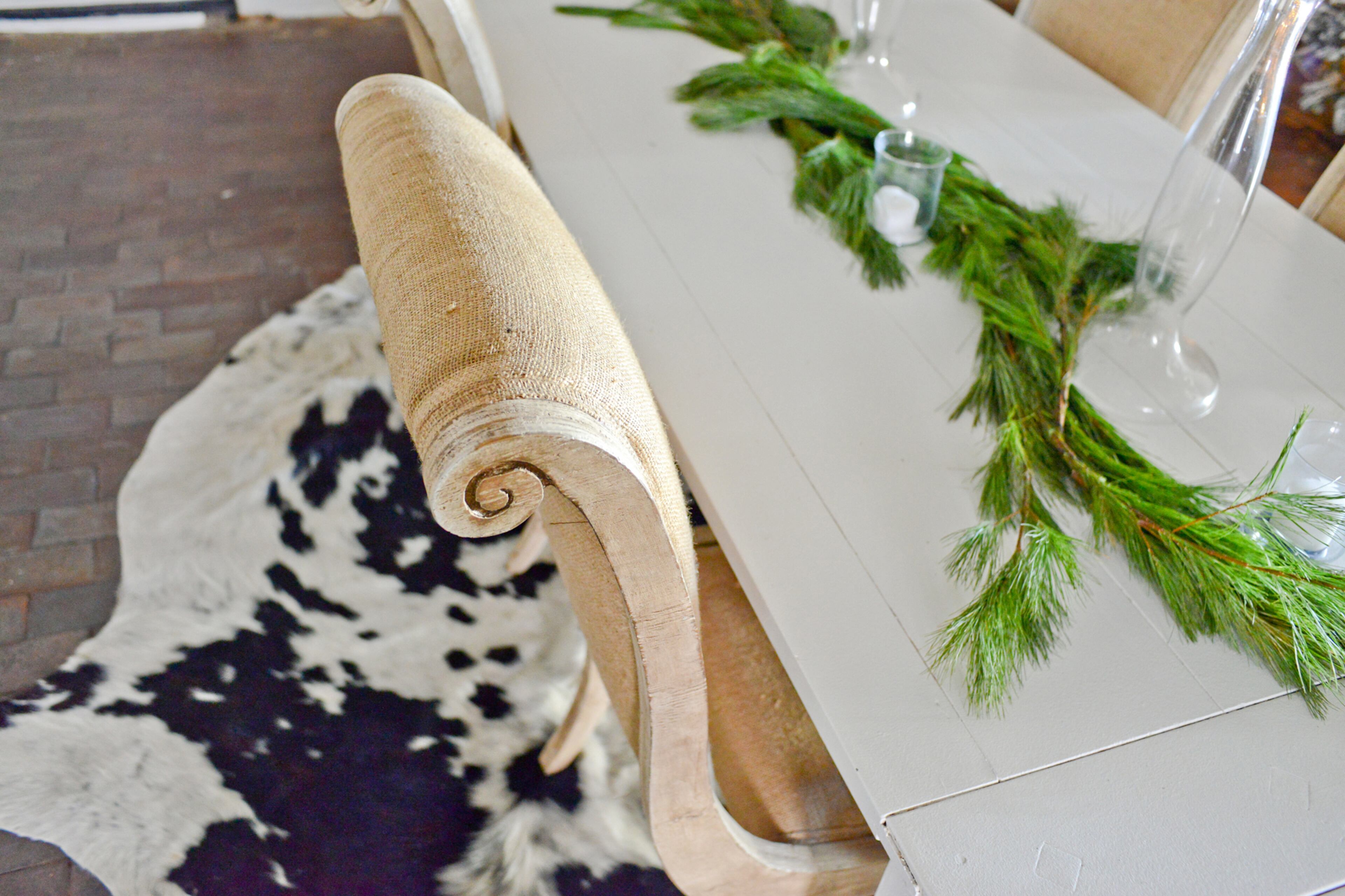 Homeowner and decorator Kelly Hawk brought antique burlap chairs into the dining room of the loft. A cowhide rug adds interest to the brick floors of the former meatpacking factory in Atlanta's Castleberry Hill neighborhood.