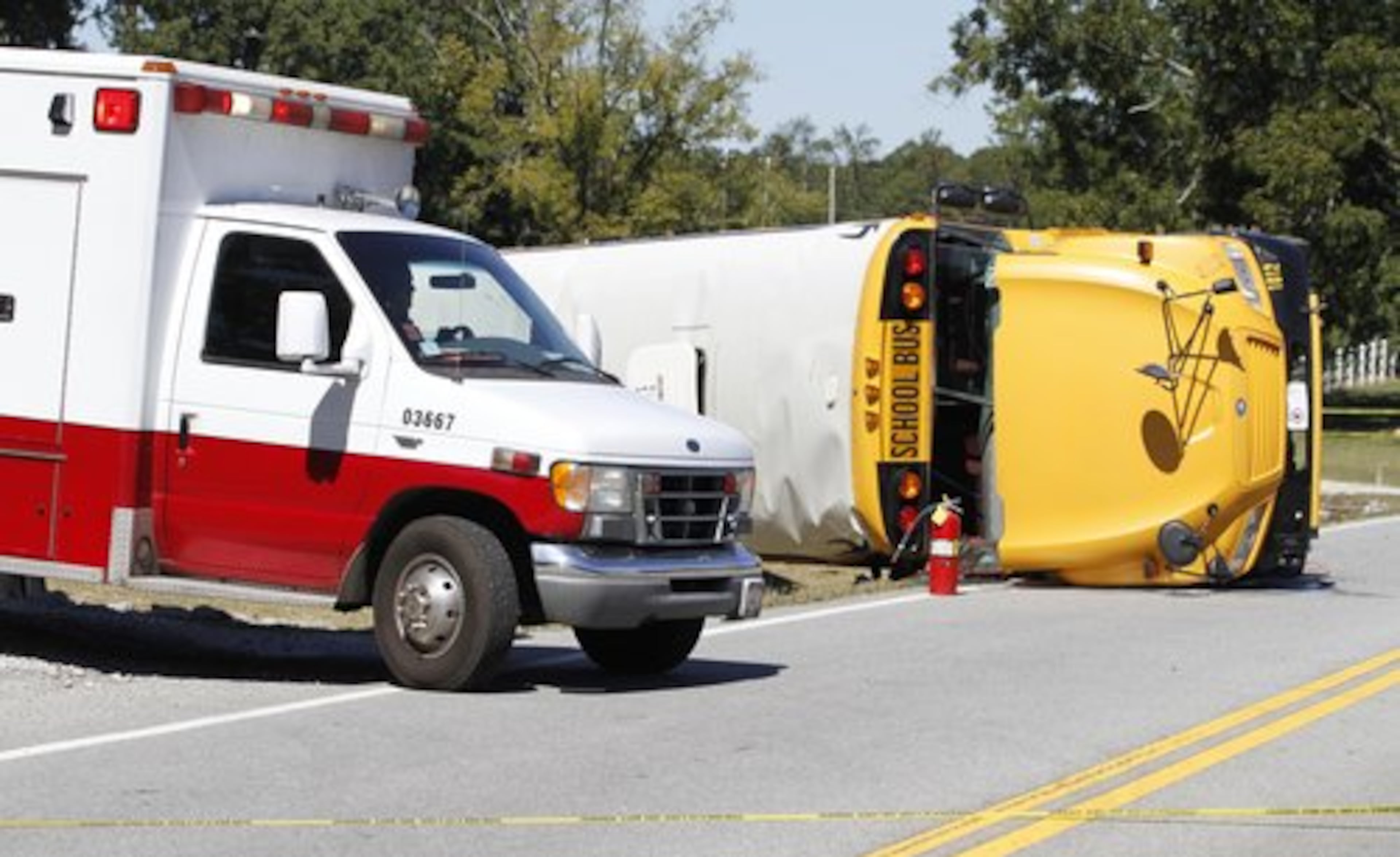 An ambulance leaves the scene where a Temple High School bus overturned on Hwy 113 between Temple and Carrollton, Ga. Those injured were taken to one of four area hospitals for treatment.