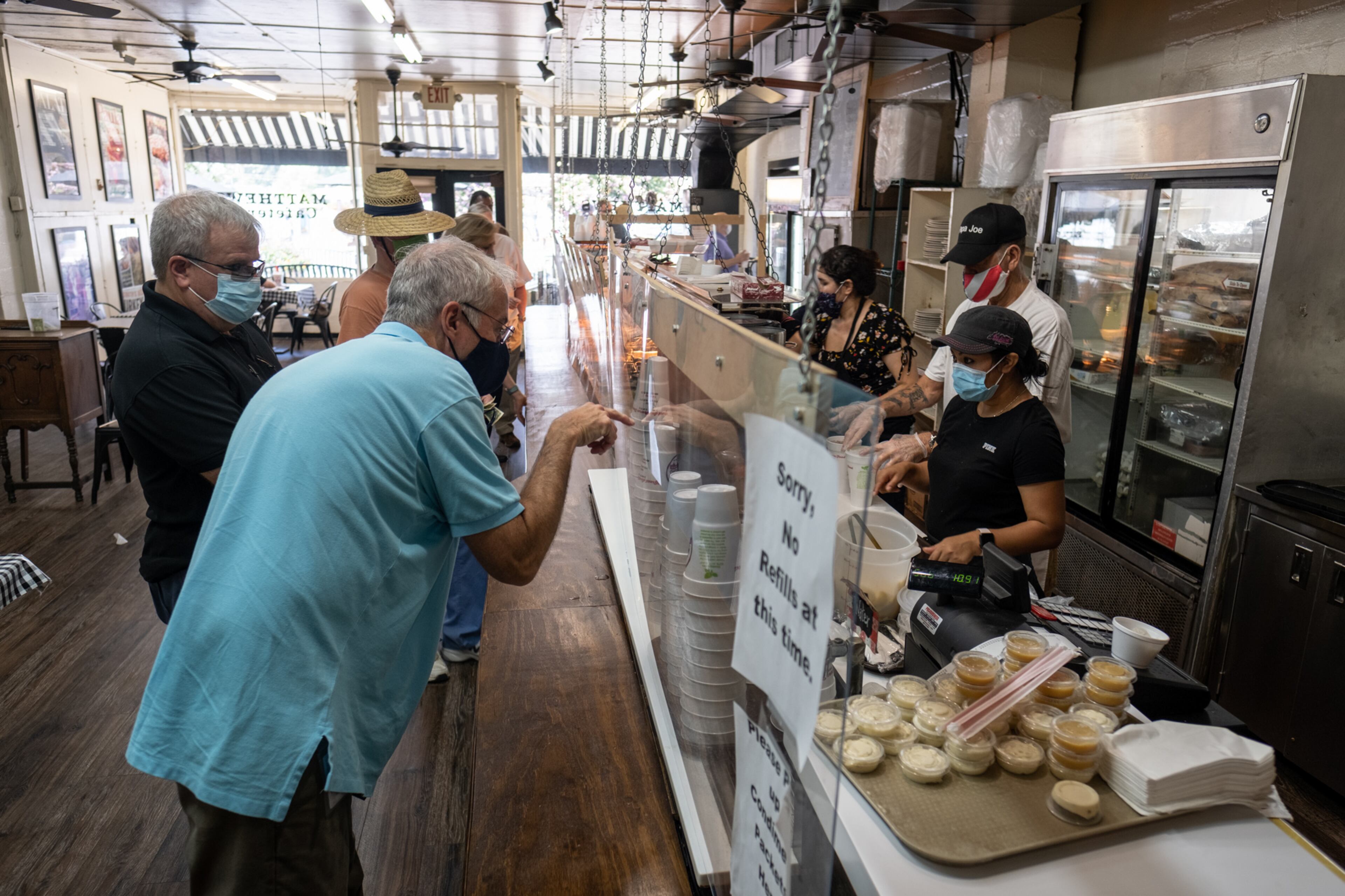 200717-Tucker-Edmund Roper points and asks for a lemon wedge while ordering at Matthews Cafeteria on Main Street in Tucker on Friday afternoon July 17, 2020. The dining institution, established in 1955, ask customers to wear masks, added the acrylic dividers, made separate entrance and exit doors and have drive-up service. Ben Gray for the Atlanta Journal-Constitution