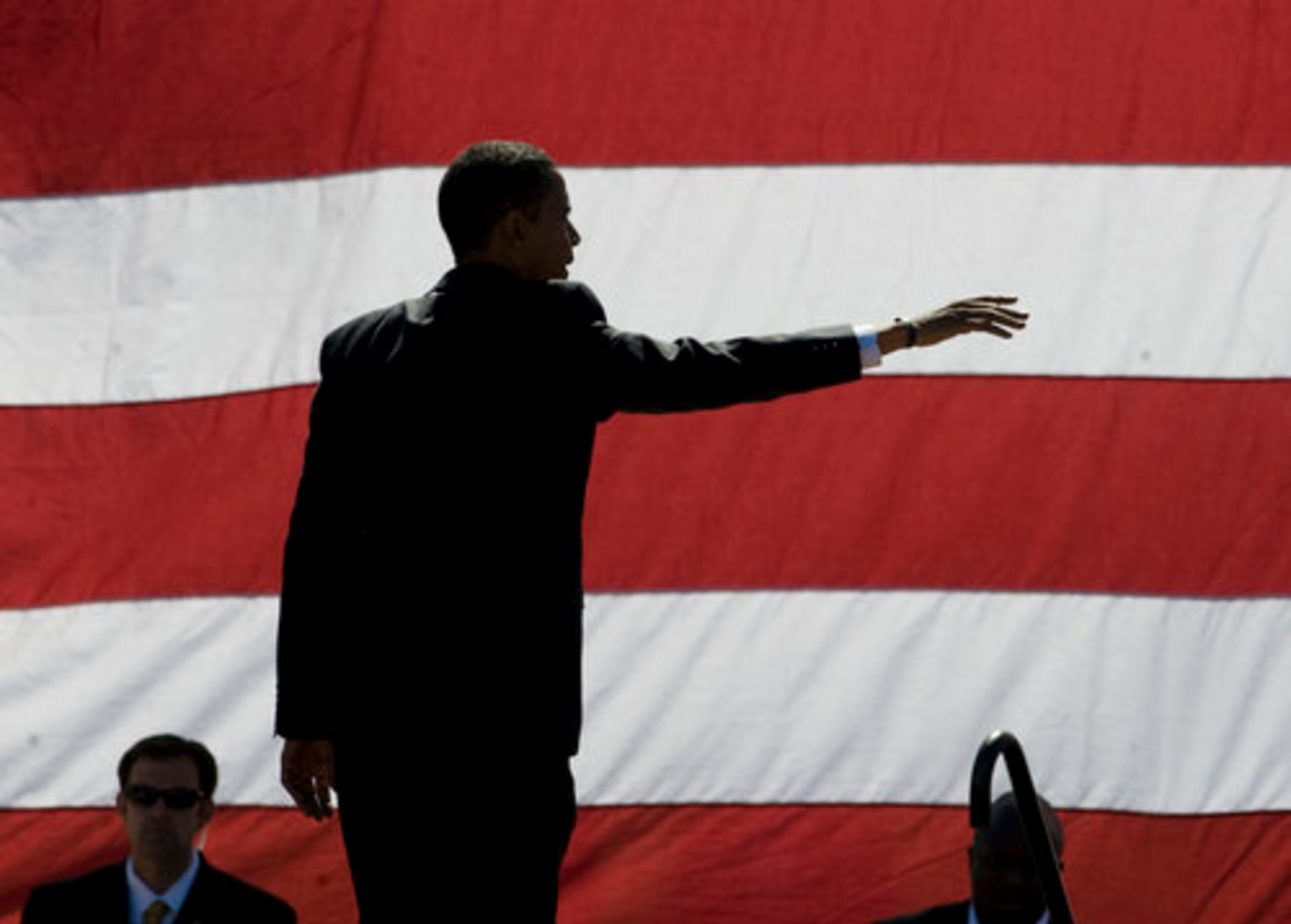 With the American flag as a backdrop, Obama leaves a Sarasota, Fla., campaign rally in late October. He was the first African-American editor of the Harvard Law Review and won a Grammy for the audio version of his book, "Dreams From my Father: A Story of Race and Inheritance."